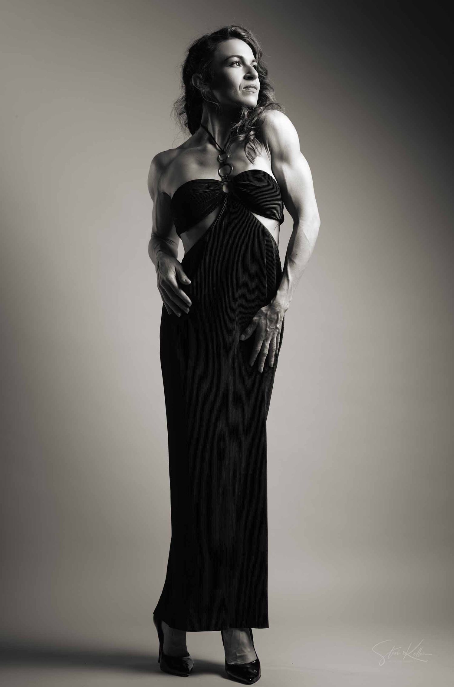Elegant noir photography series showing graceful poses in a black dress against light studio backdrop.