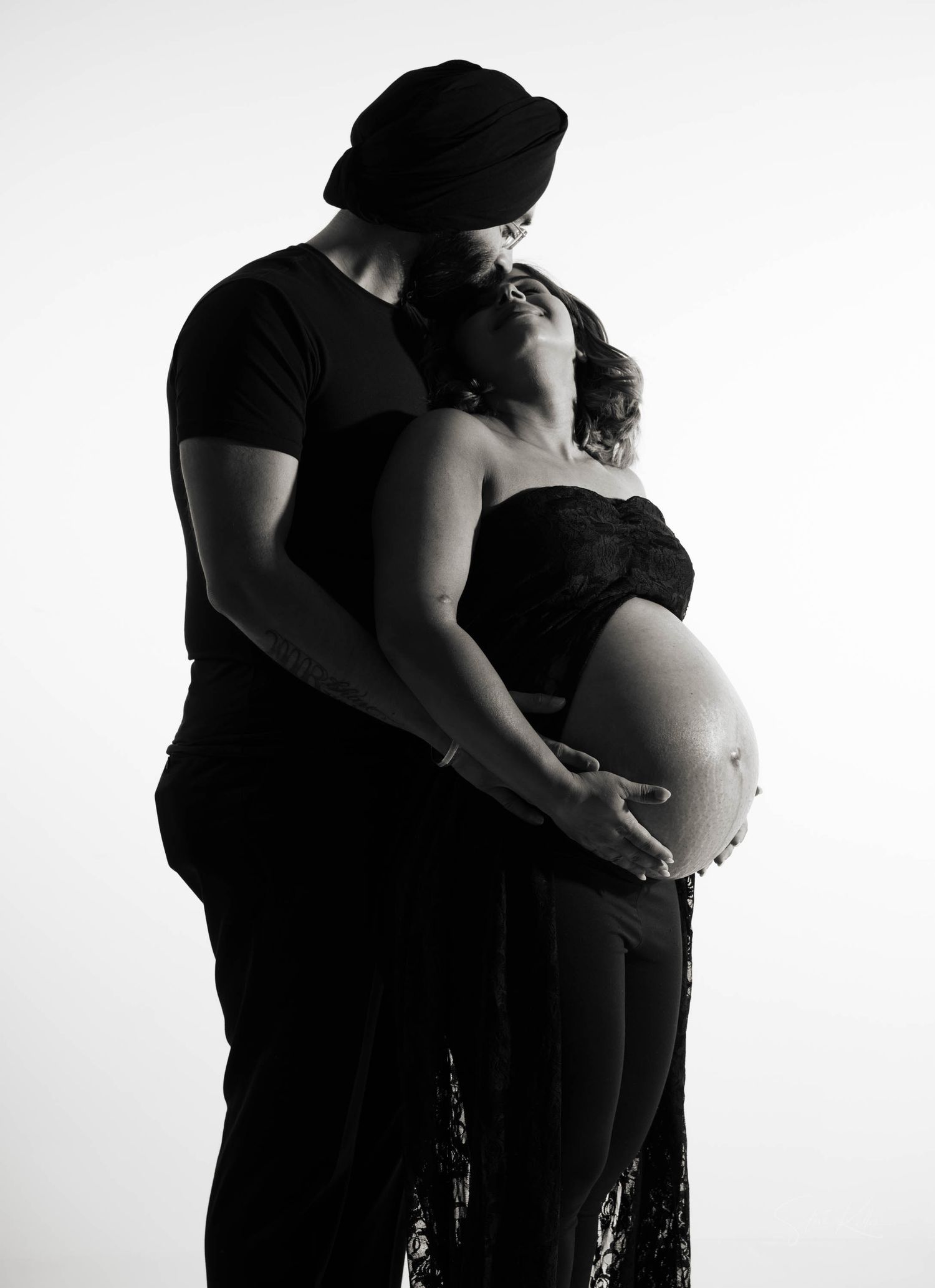 Silhouette series of maternity photos showing pregnant woman and partner in black against white background.