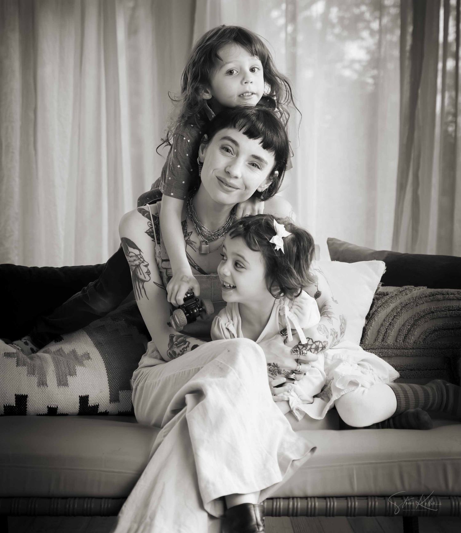 A series of black and white photographs showing tender moments between a parent and child in soft window light.