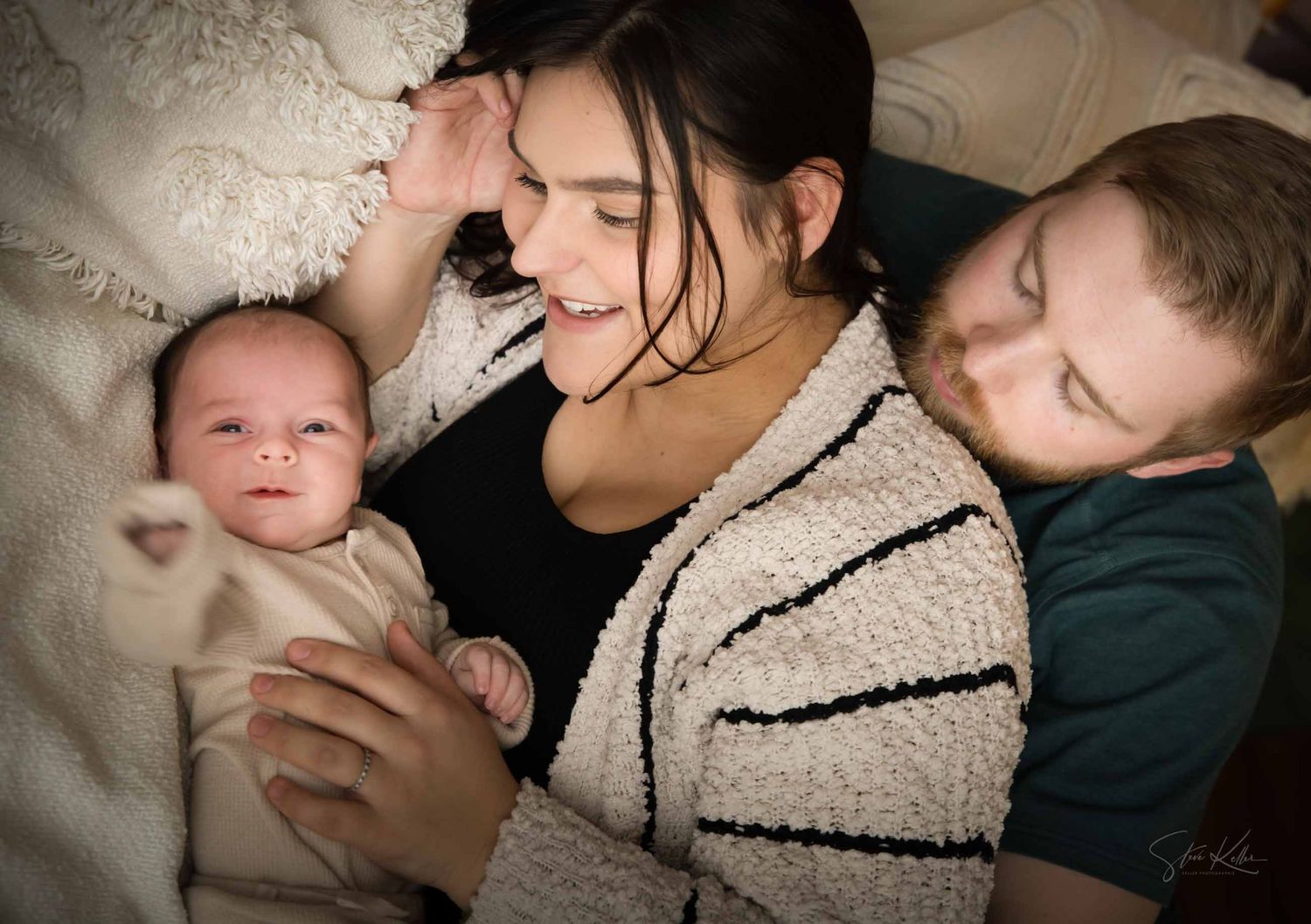 A series of intimate black and white photographs showing tender moments between parent and baby in soft lighting.