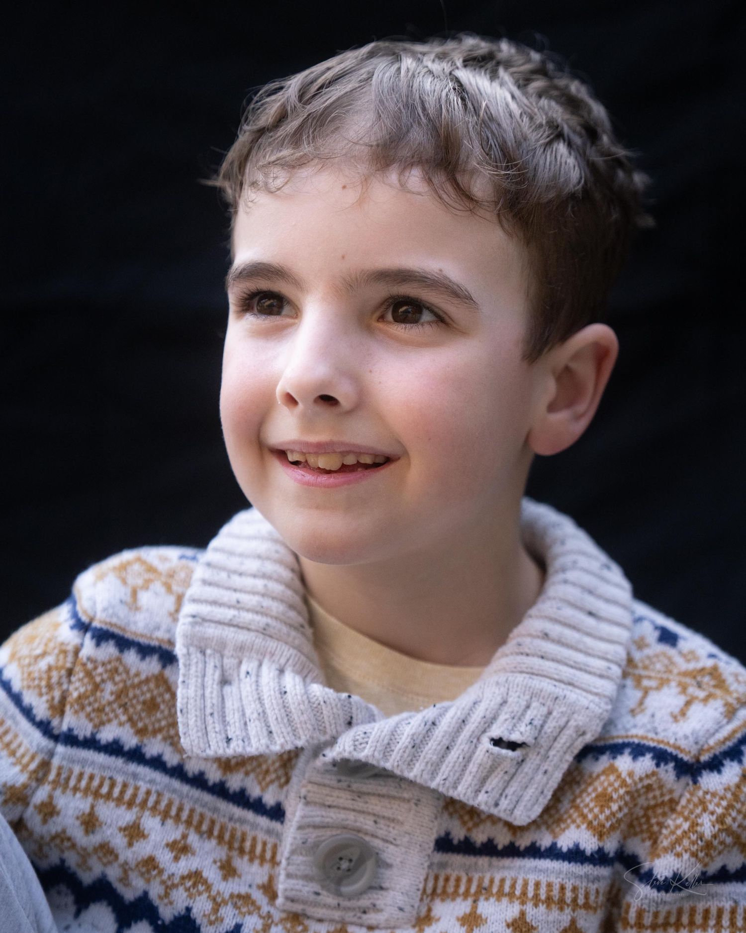 A sequence of close-up shots showing a person in a patterned knit sweater looking upward with a gentle smile.