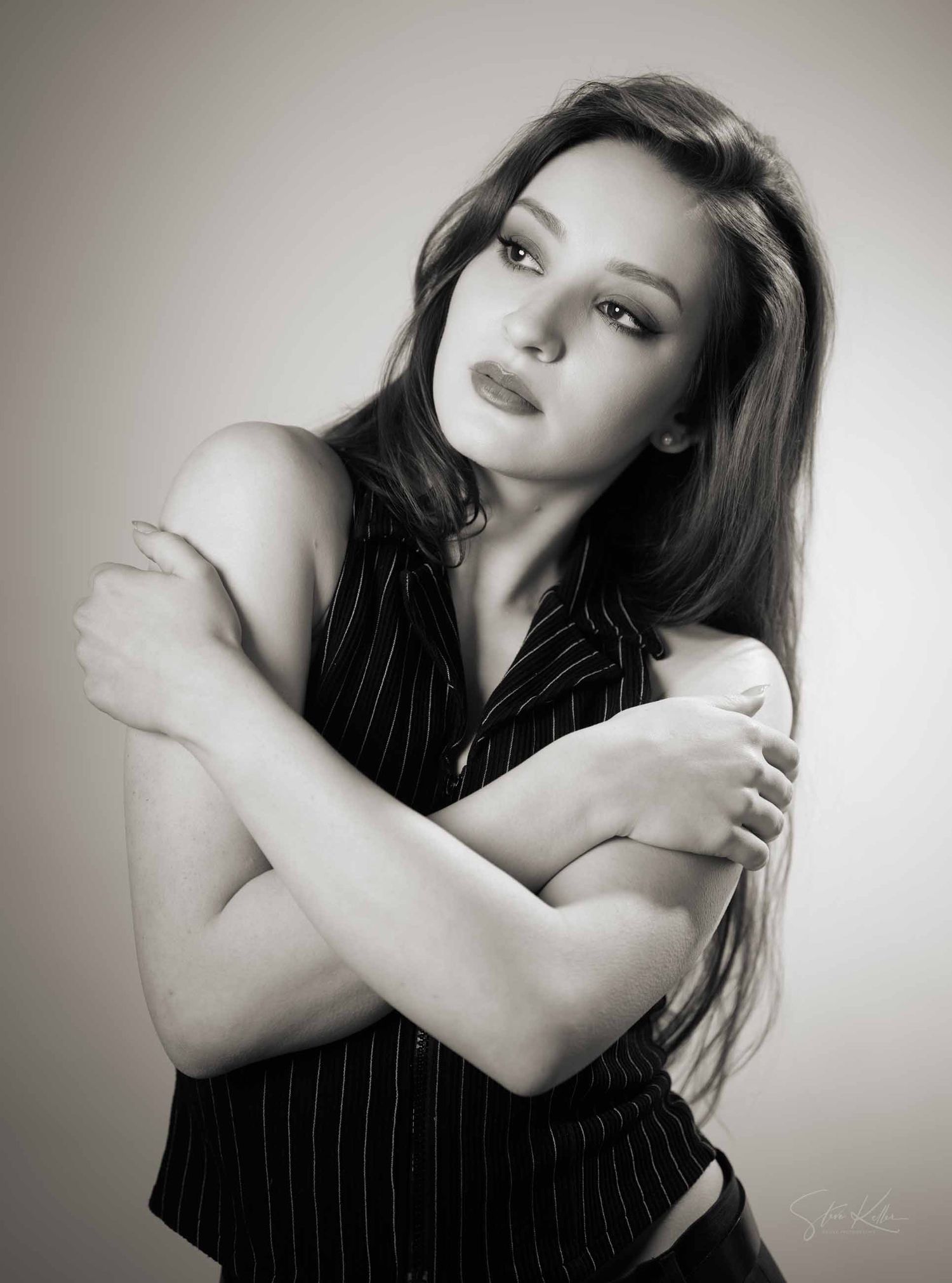 Artistic black and white portrait series showing dramatic poses against neutral background with moody lighting.