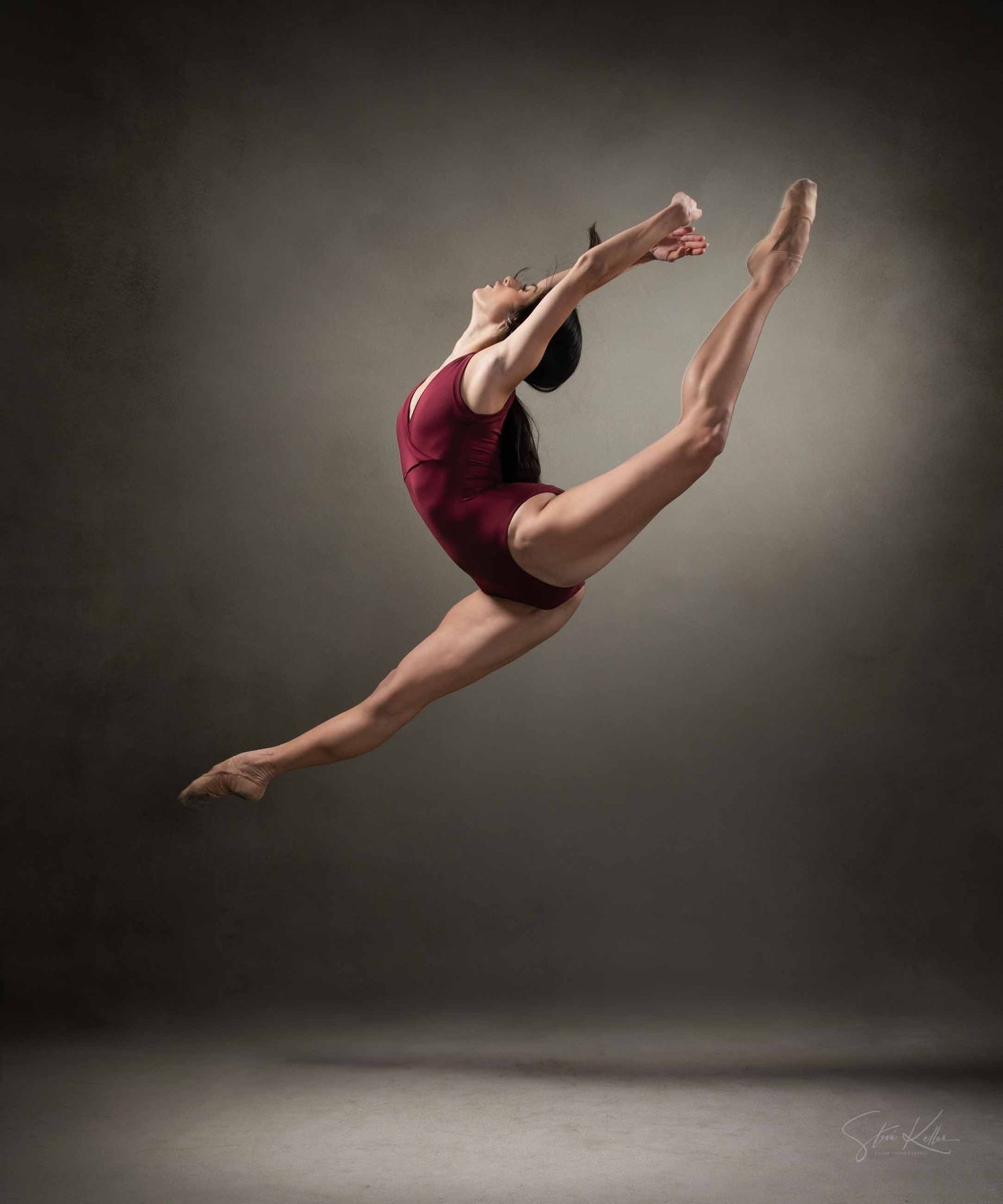 A sequence of dynamic dance movements captured in burgundy attire showing graceful leaps and aerial poses against dark backdrop.