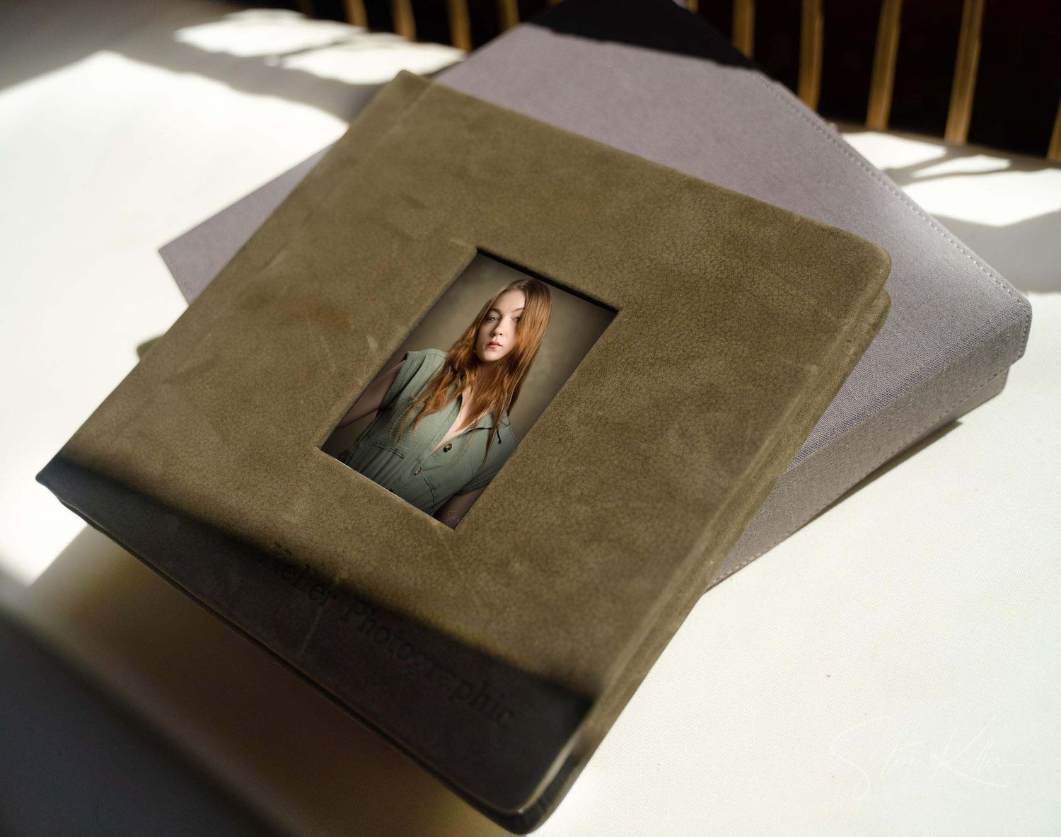 A series of photo album pages showing progressively closing angles of a leather-bound book with mounted photographs.