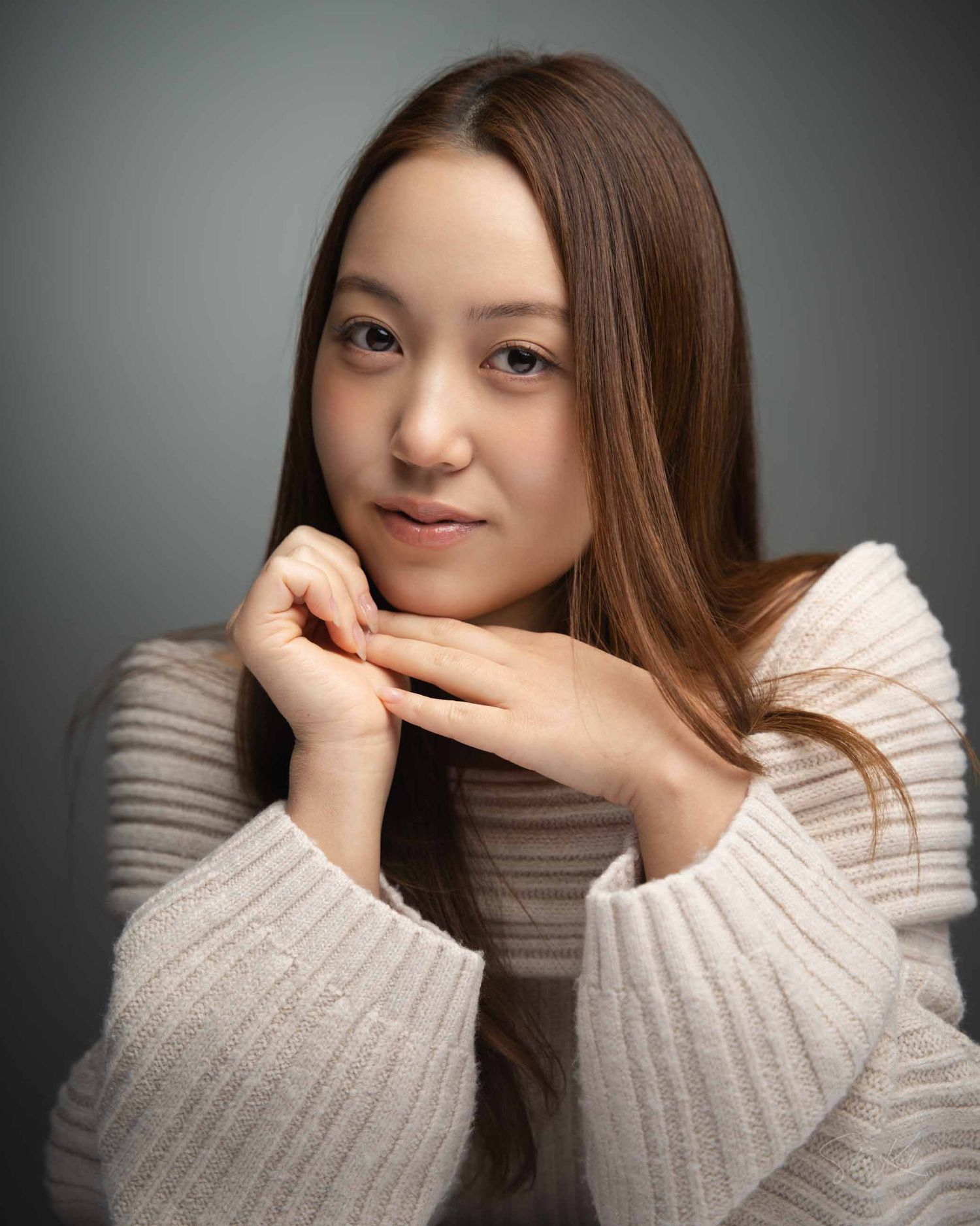 A sequence of portrait shots showing someone in a beige sweater expressing different emotions and gestures.