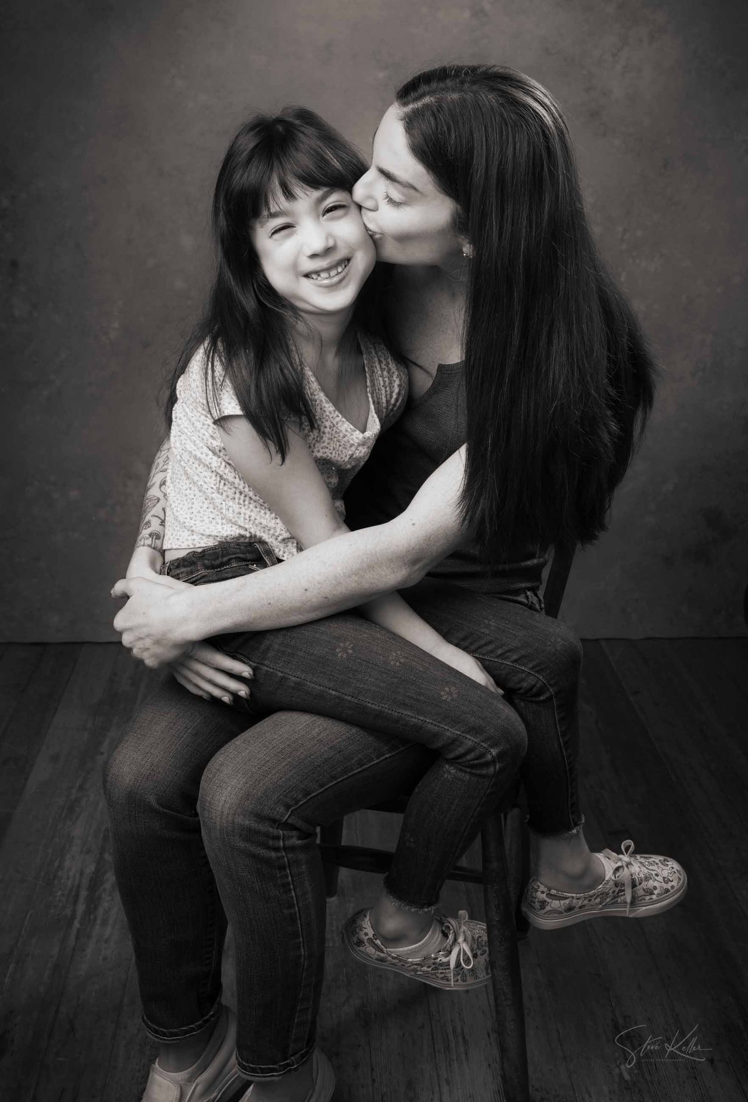 A heartwarming black and white photo series showing tender moments between parent and child sitting together.