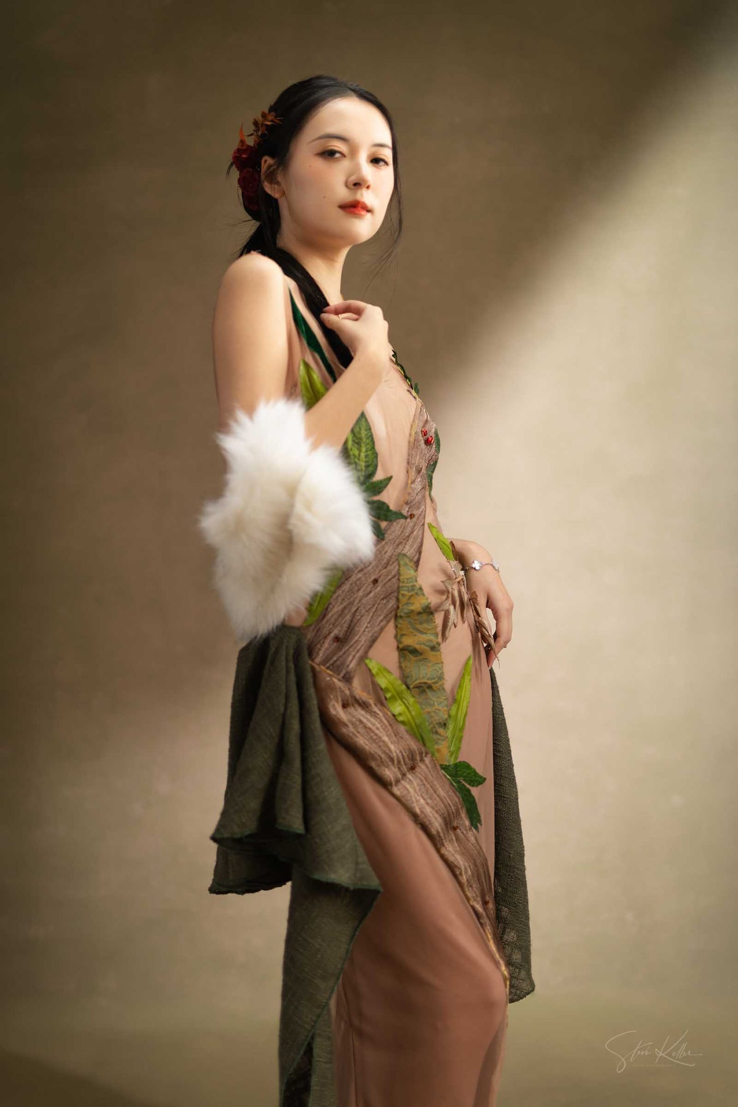 Artistic portrait series showing a model in brown dress and white fur shawl posing against neutral backdrop in studio lighting.