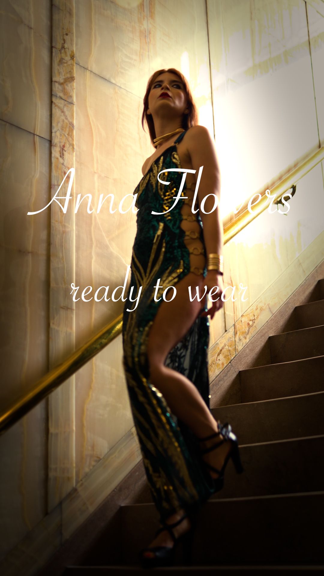 A person in a sequined dress poses dramatically on a staircase in moody lighting creating an artistic silhouette effect.