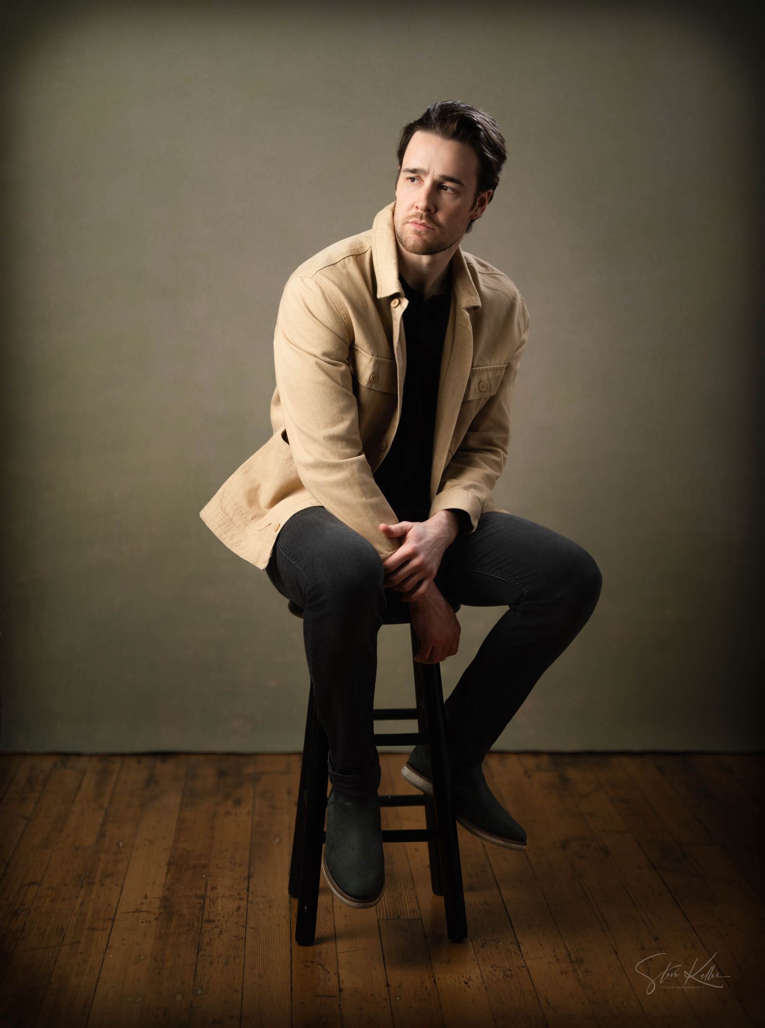 Professional portrait series showing a person in a tan blazer and dark pants seated on a wooden stool against a dark backdrop.