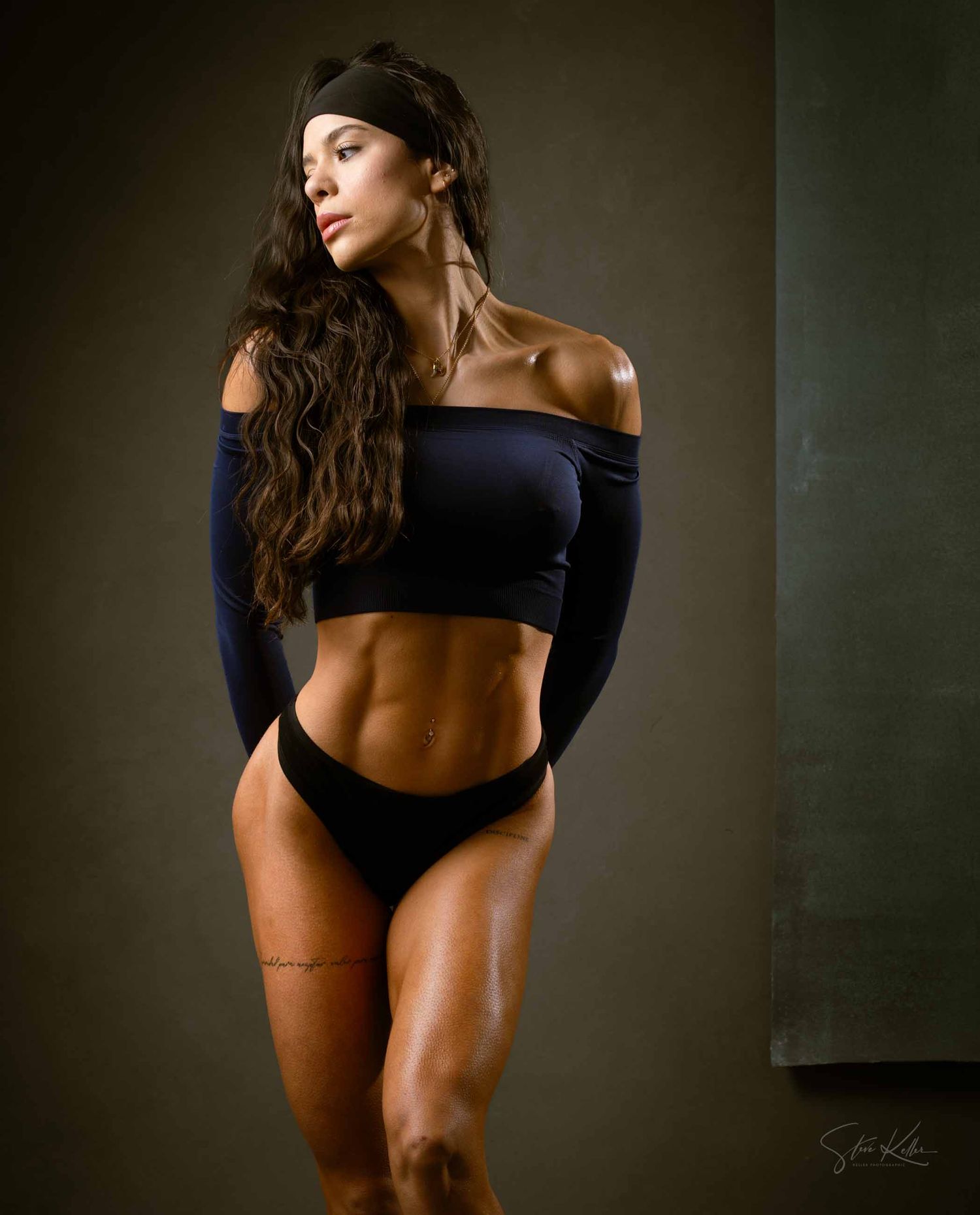 Artistic fitness photography series showing muscular physique in black athletic wear against dark moody backdrop.