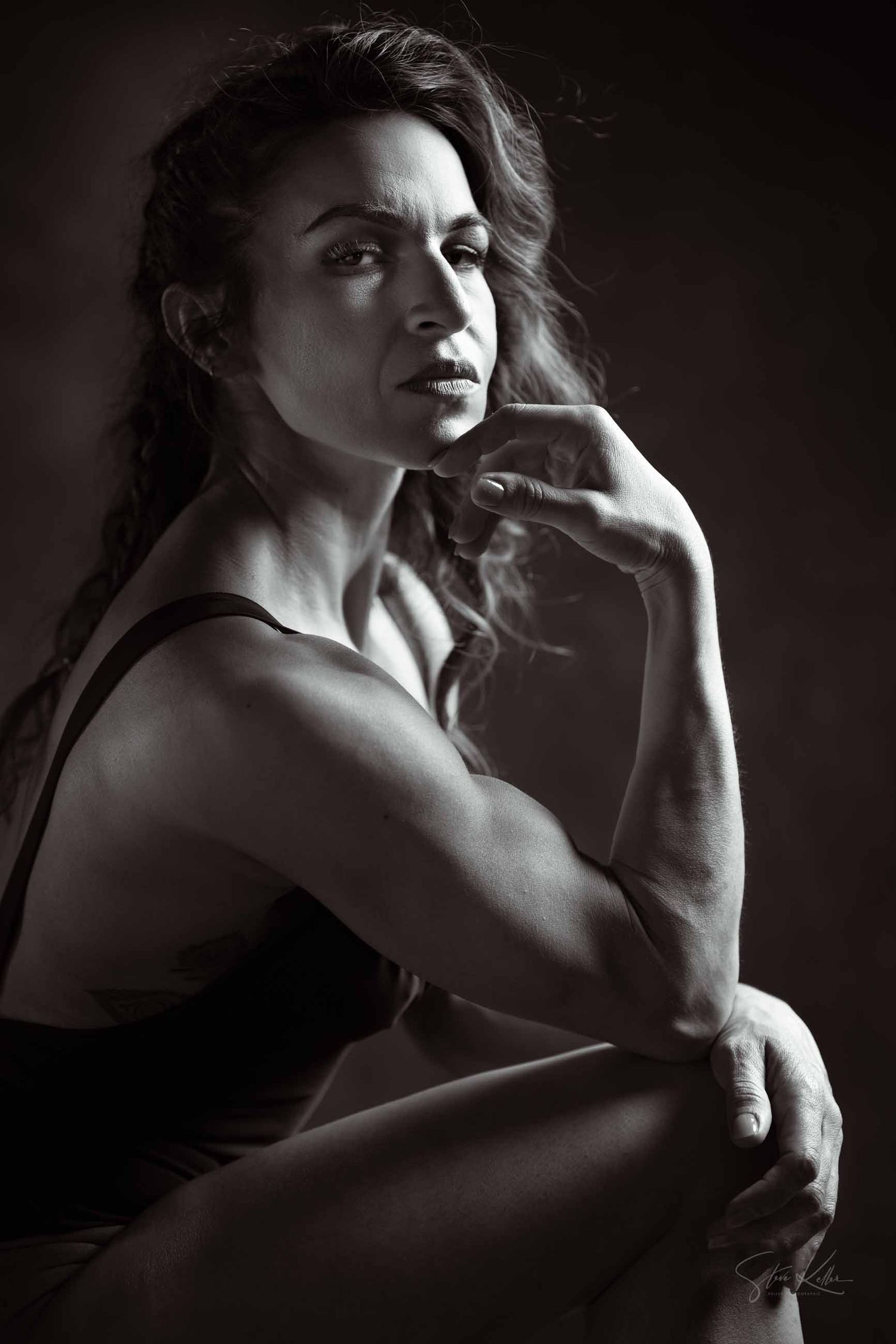 Artistic black and white portrait series showing dramatic shadows and poses in moody lighting.