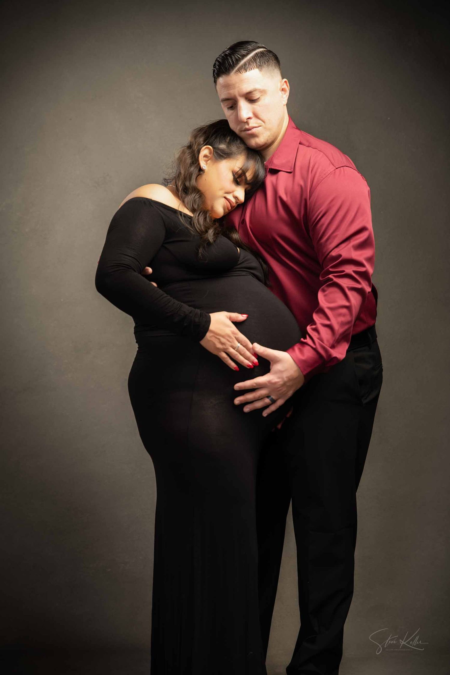 A maternity photo series showing a couple embracing in silhouette against a dark background.