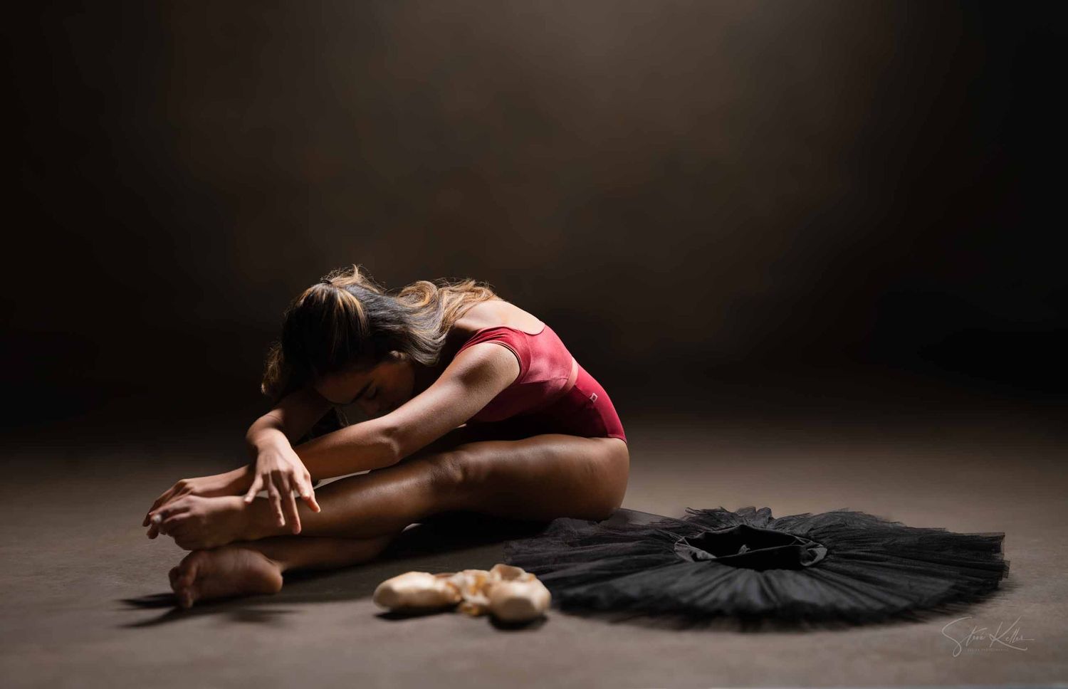 A sequence of artistic dance poses showing graceful movements in a dark studio setting.