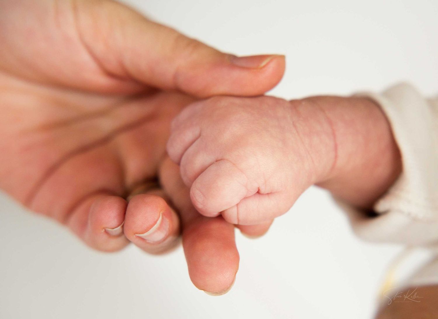 A close-up sequence of hands gently massaging and stretching fingers to demonstrate proper hand therapy techniques.