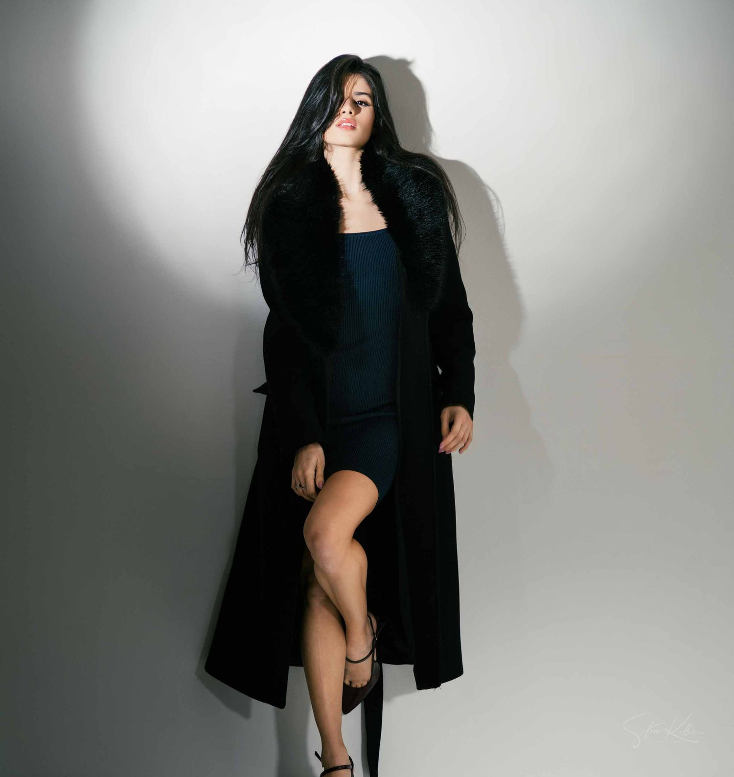 Artistic fashion photo series showing a person in black clothing posing against a white backdrop with dramatic shadows.