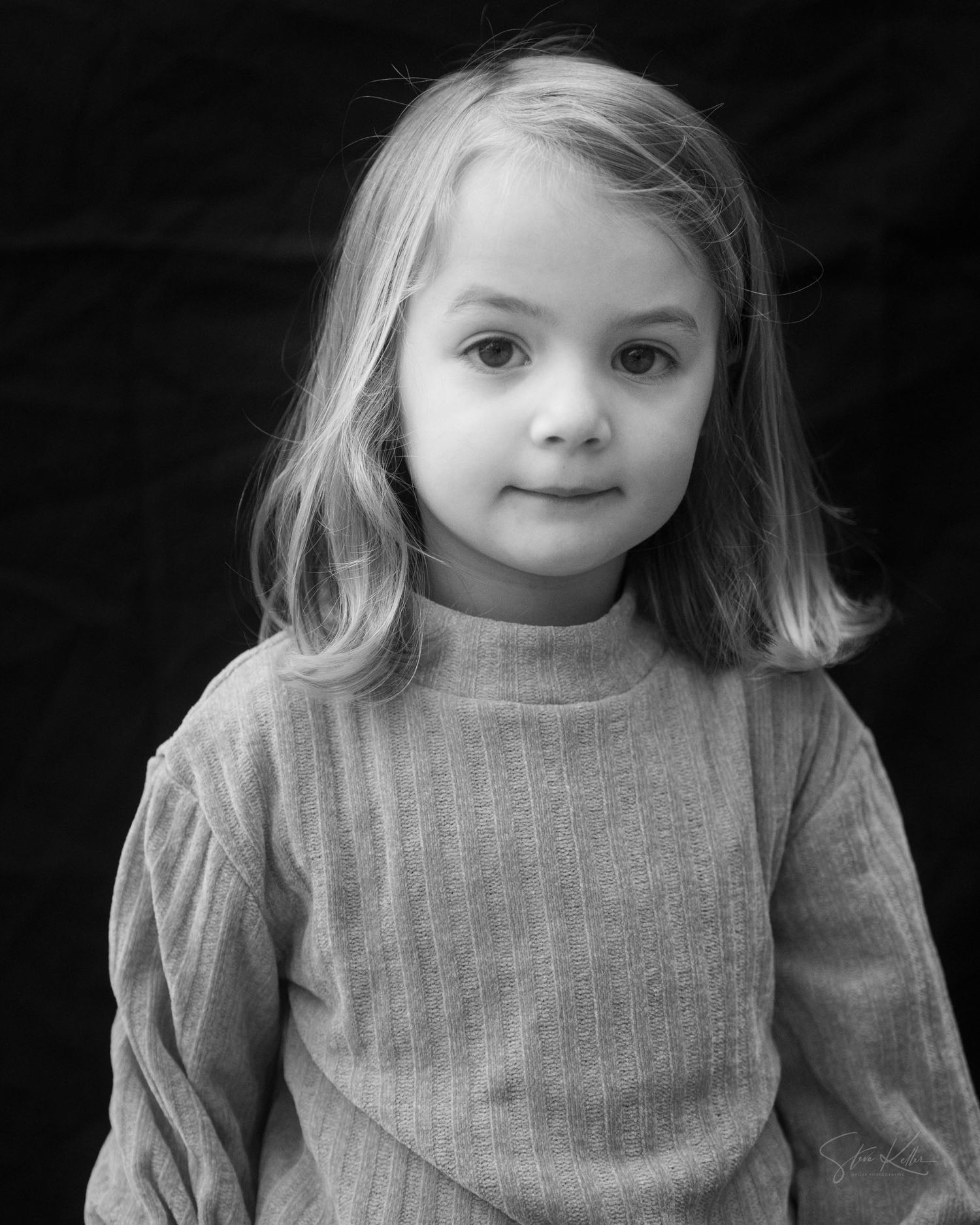 A series of black and white portraits showing a child in a turtleneck sweater with changing expressions.