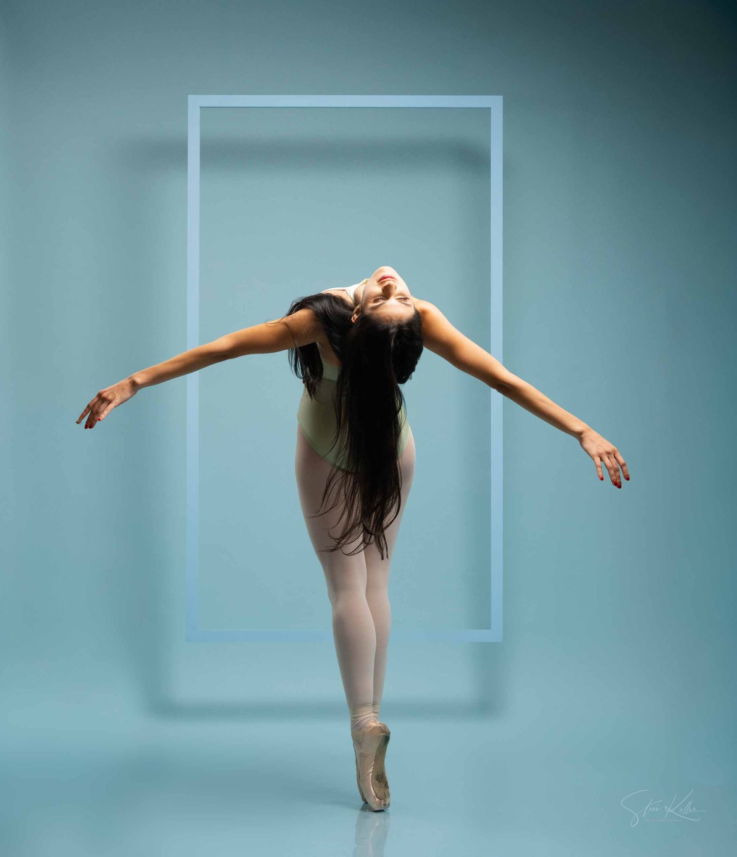 A ballet dancer in a beige leotard performs an elegant backbend sequence against a teal studio backdrop.