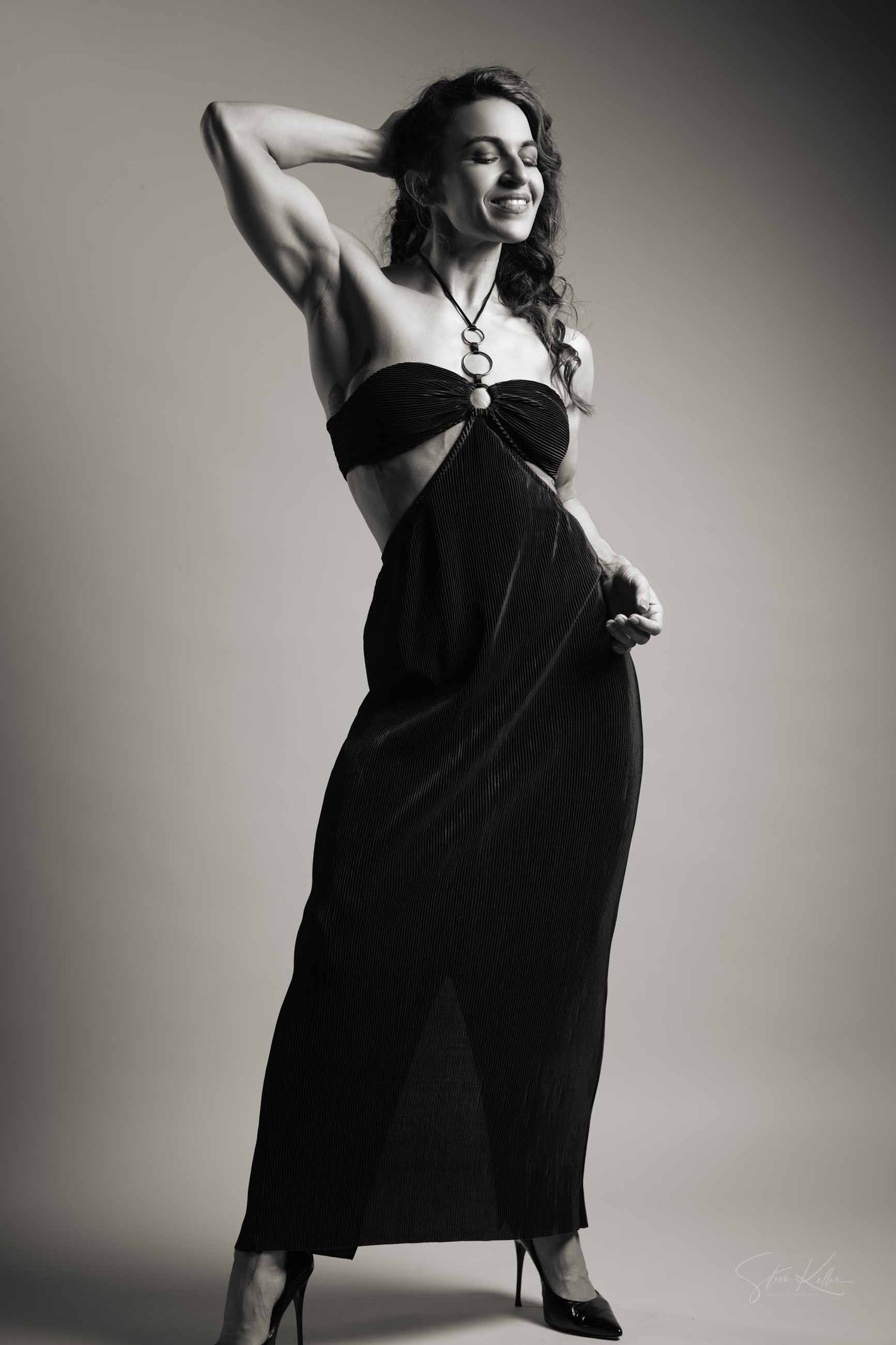 Dynamic fashion photoshoot sequence featuring movement and dramatic poses in a black sleeveless dress.