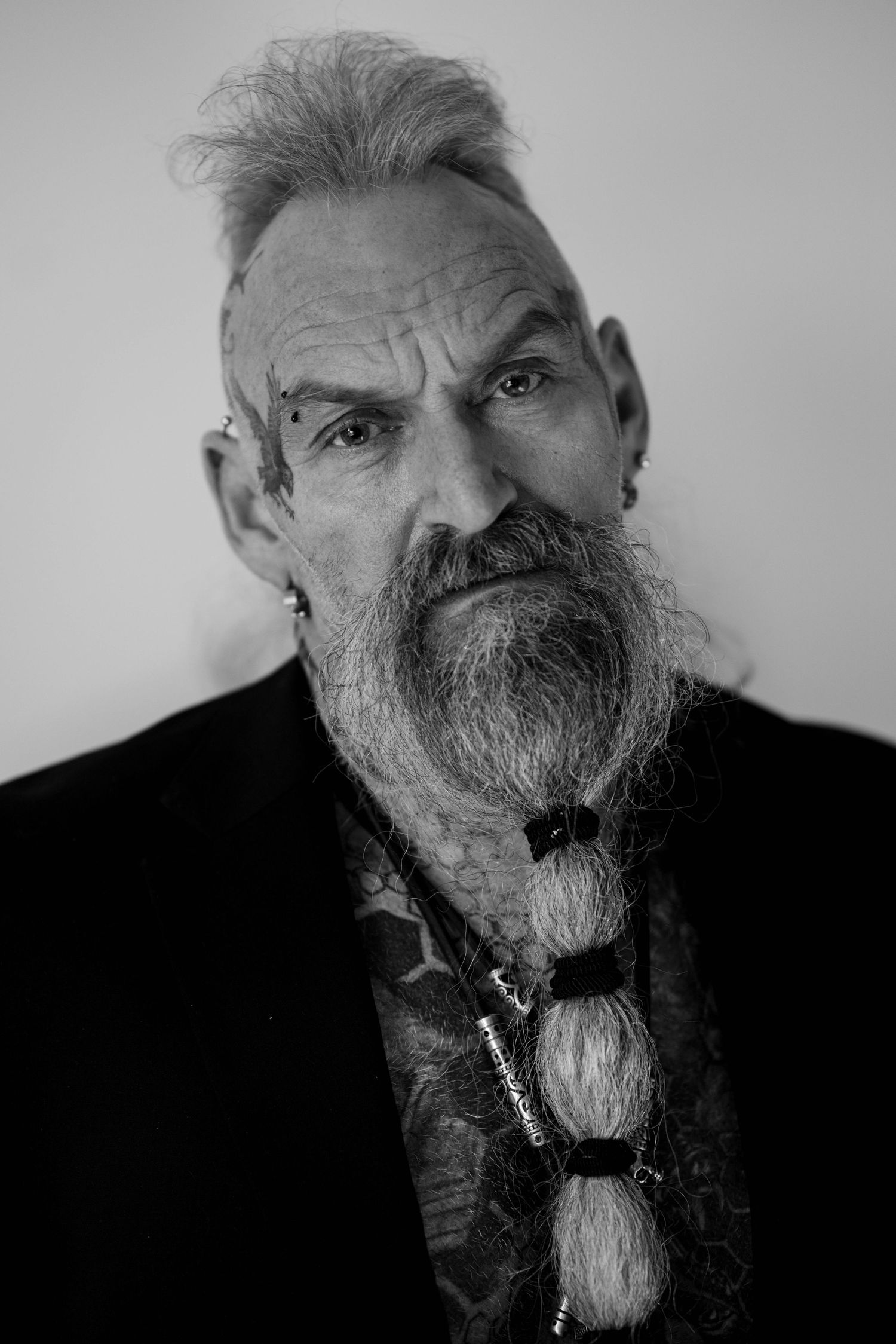 Close-up black and white portrait showing detailed beard and intense expression.