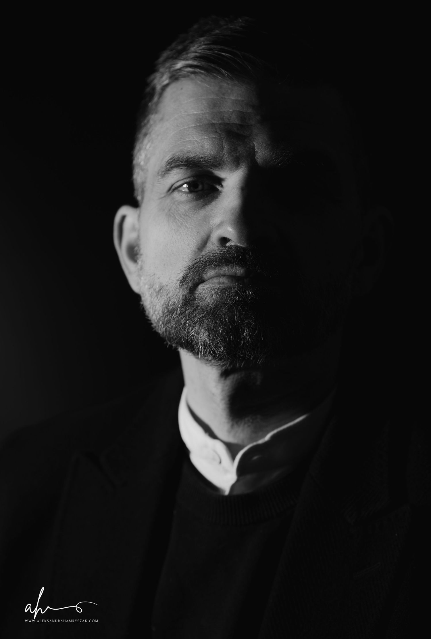 A dramatic black and white portrait study showcasing different angles of a bearded figure against a dark background.