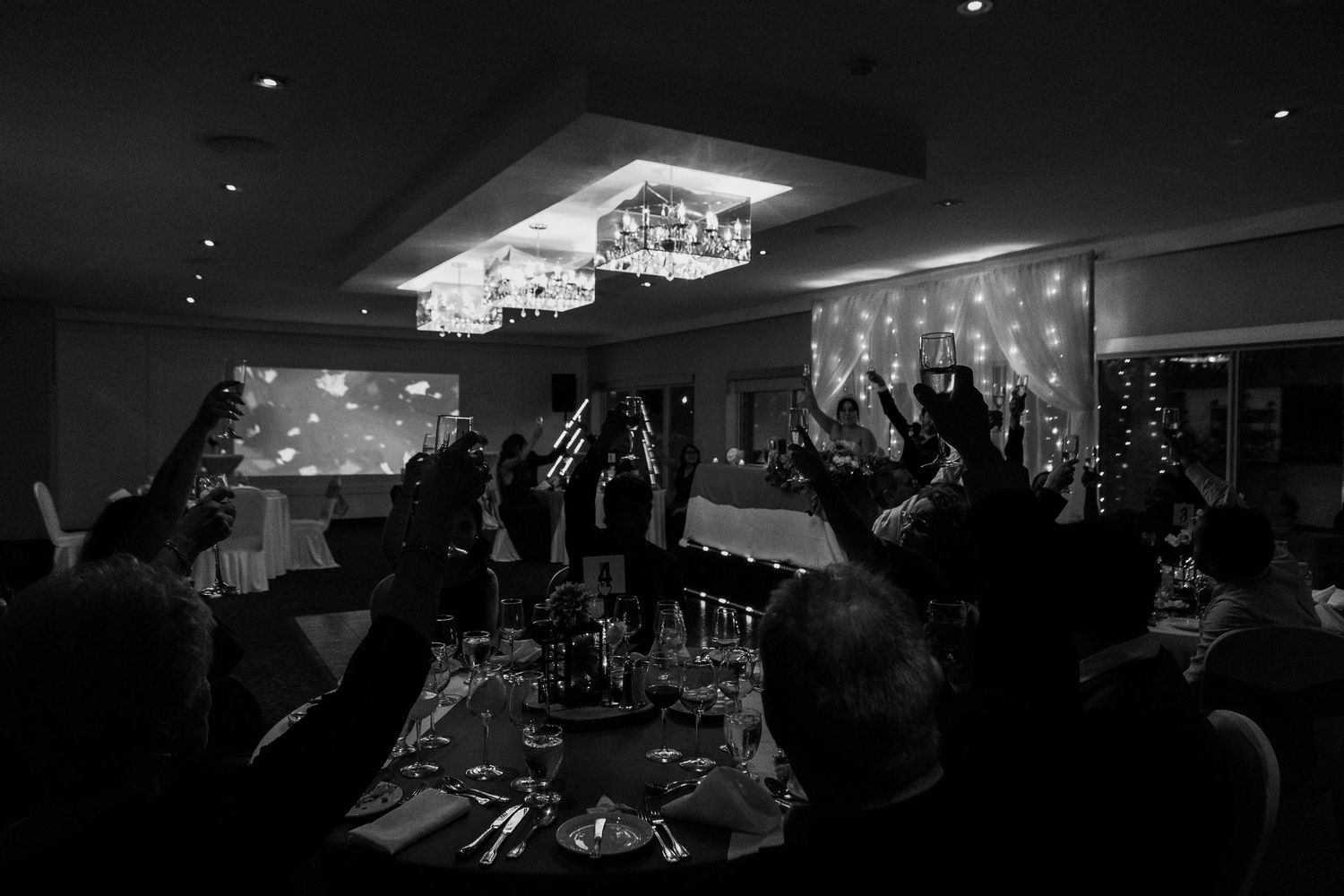 A dimly lit nightclub interior with a dance floor and glowing ceiling lights creates an atmospheric party ambiance.