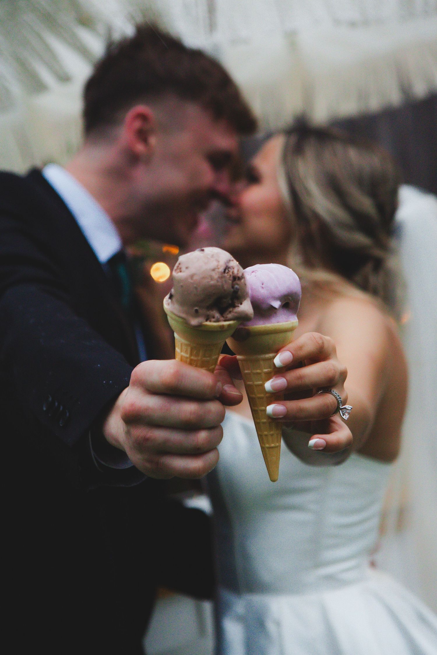 A couple in formal wedding attire shares ice cream cones together in a series of romantic close-up shots.