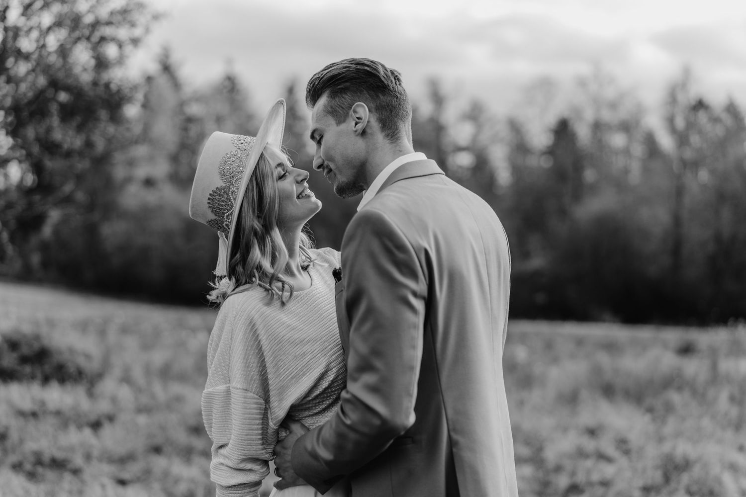 A romantic engagement photo series showing a couple embracing in a natural outdoor setting at sunset.