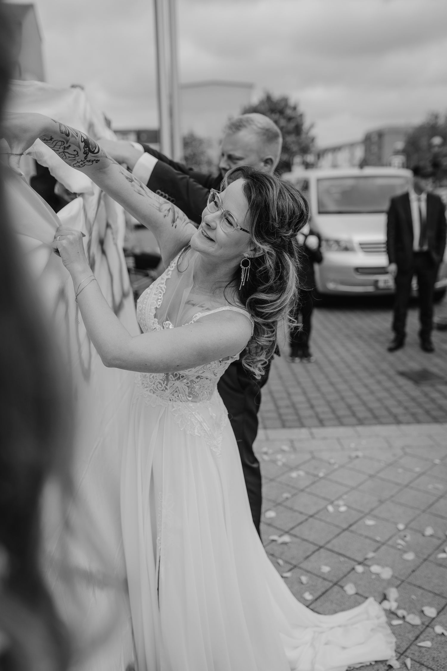 Black and white photo sequence showing couple taking shots together at outdoor reception area.