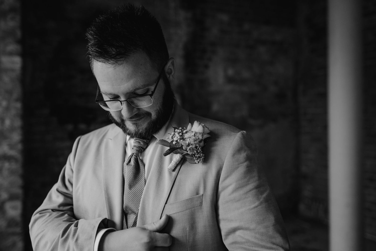 Couple shares an intimate moment in monochrome with delicate floral details.