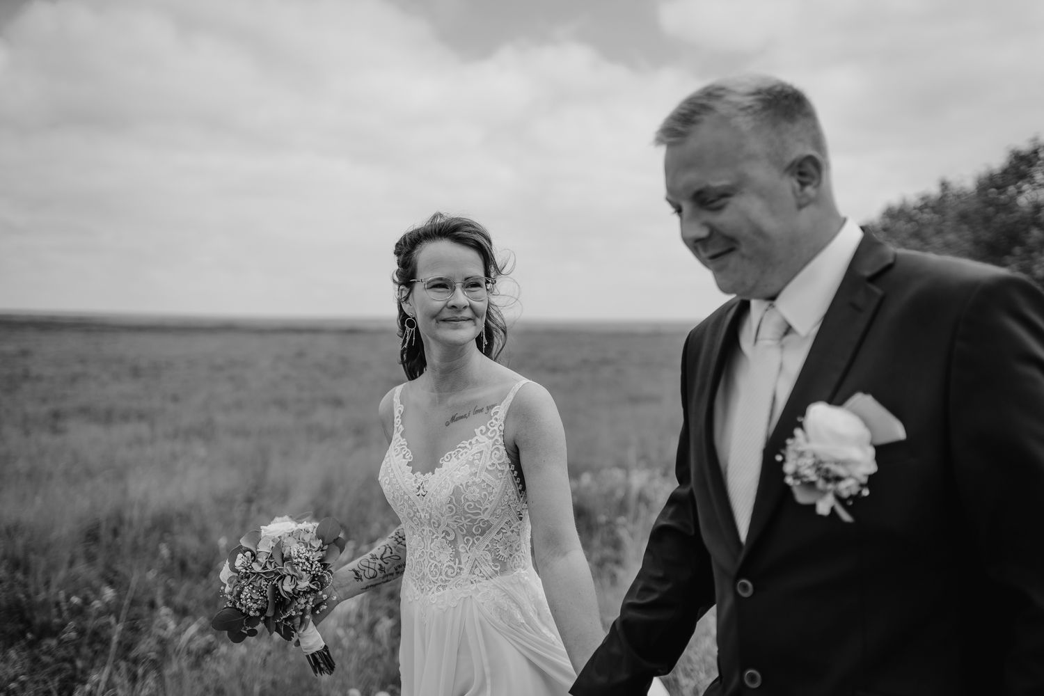 Black and white wedding photography series showing intimate moments between newlyweds in outdoor settings.