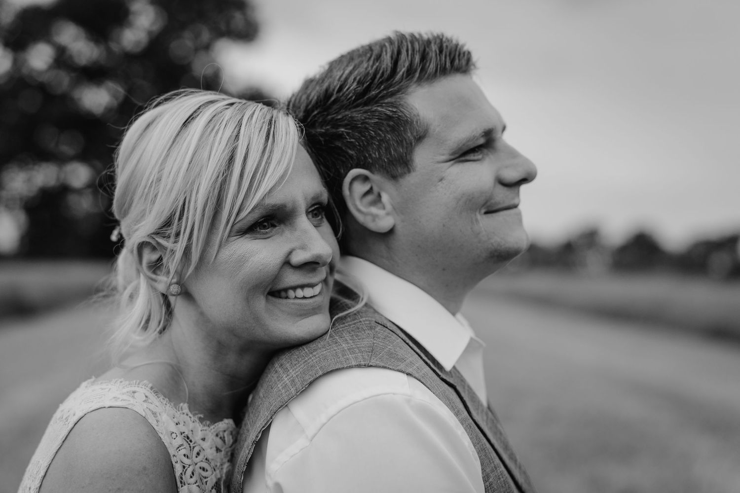 Black and white candid portraits captured during an intimate outdoor wedding moment.