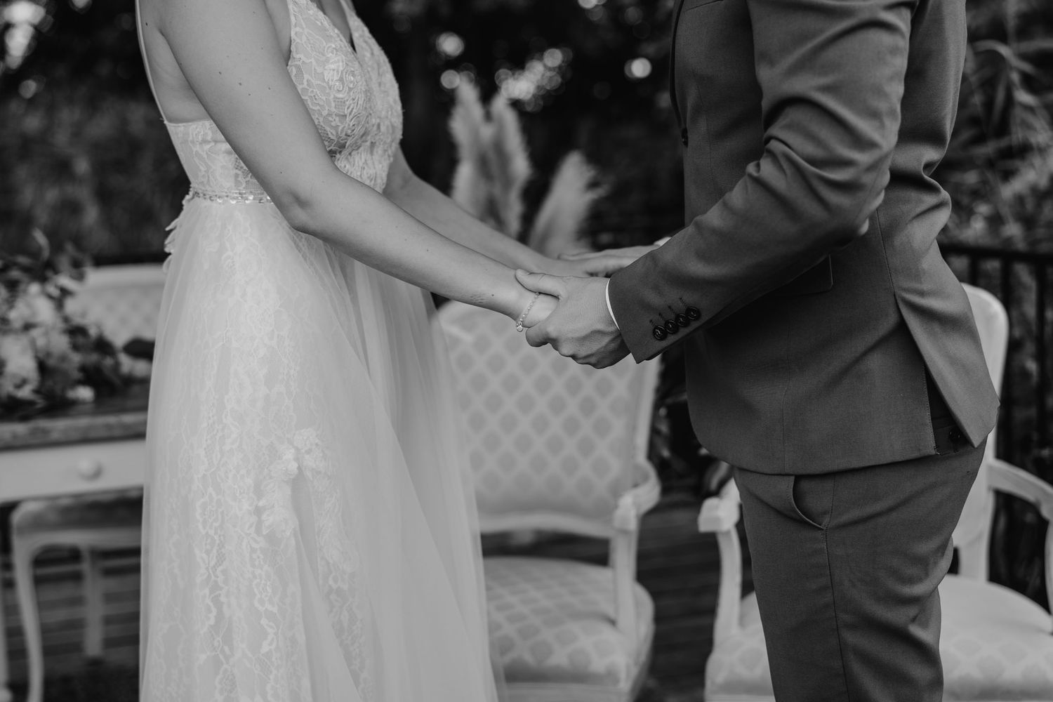 Black and white wedding ceremony photos showing moments between couple during their special day.