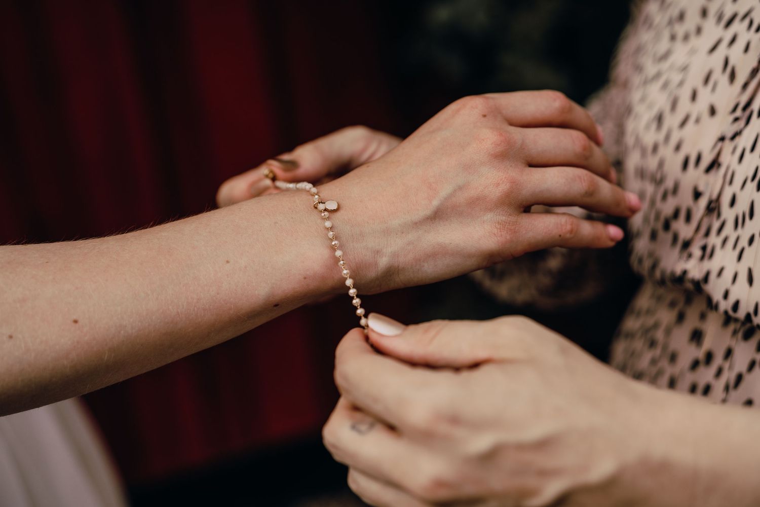 Close-up of hands exchanging rings during an intimate wedding ceremony moment.