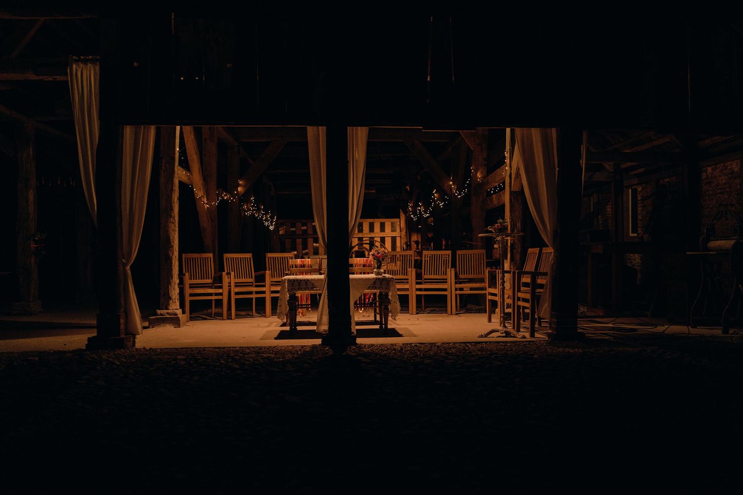 Dark atmospheric shot of an empty wedding reception venue setup.