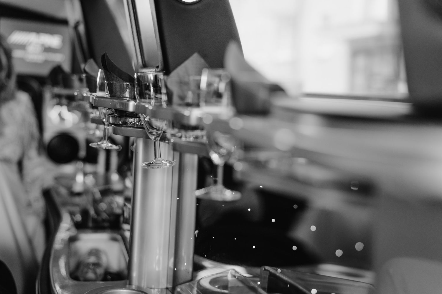 Close-up view of beer tap handles at a bar in black and white with shallow depth of field.
