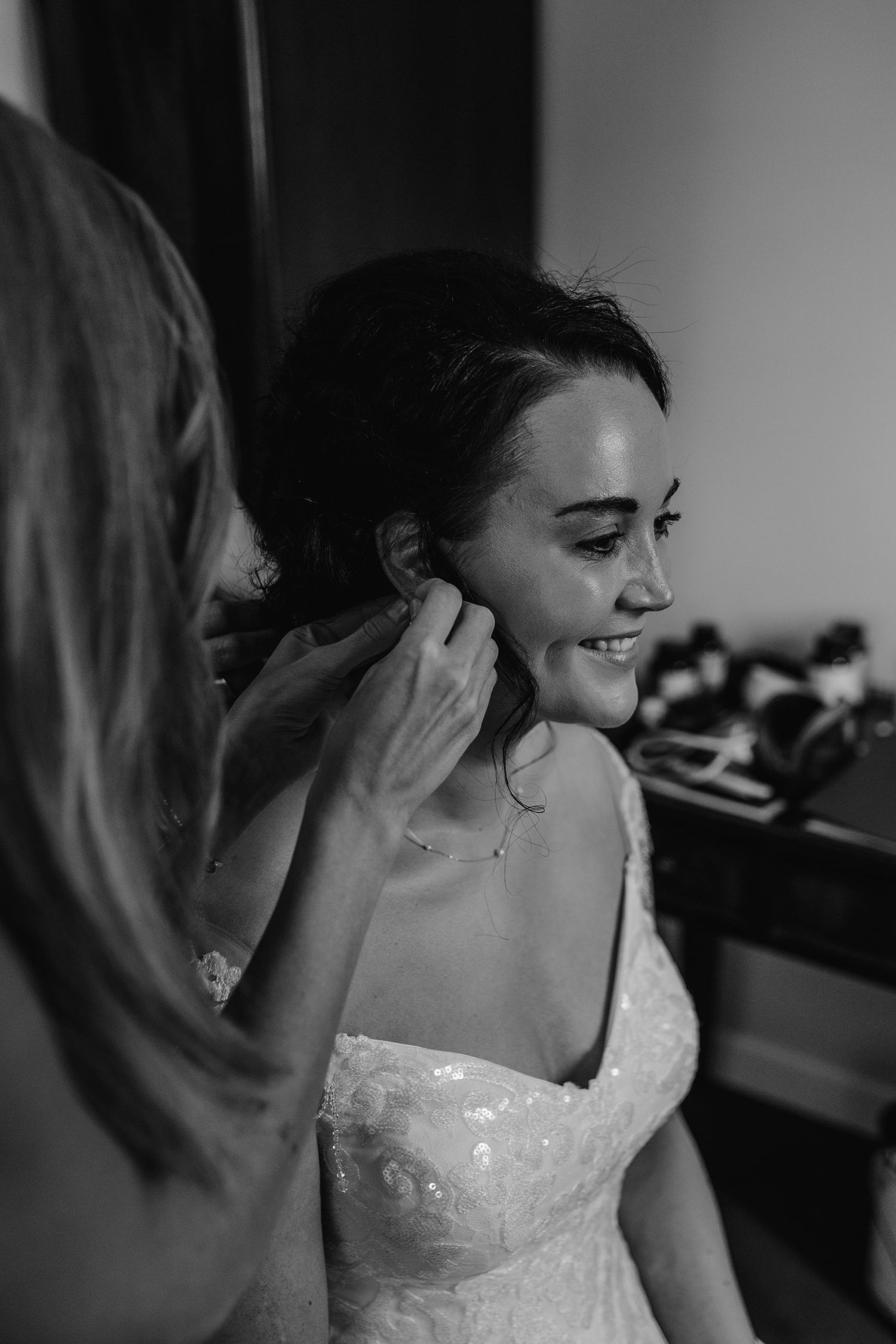 A wedding preparation moment showing final touches being made to bridal accessories.