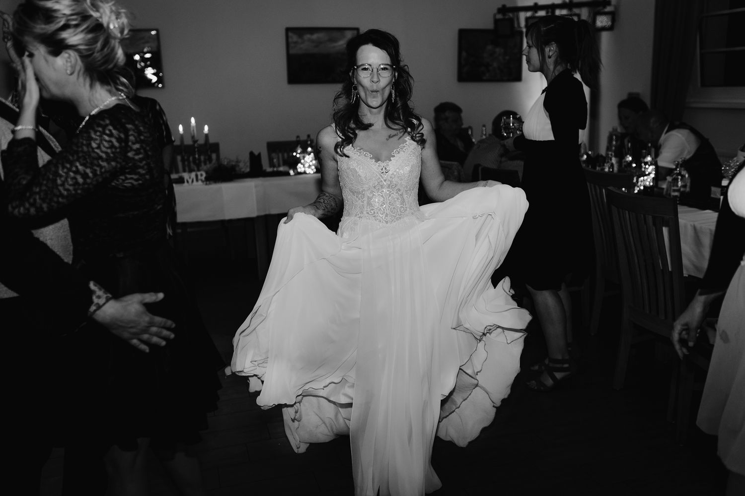 Black and white photo sequence showing people dancing during a wedding reception or celebration.
