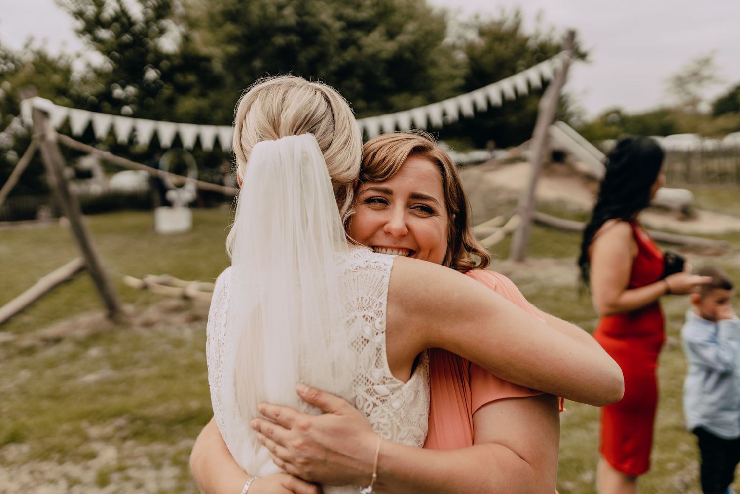 An emotional wedding celebration moment captured during an outdoor reception.