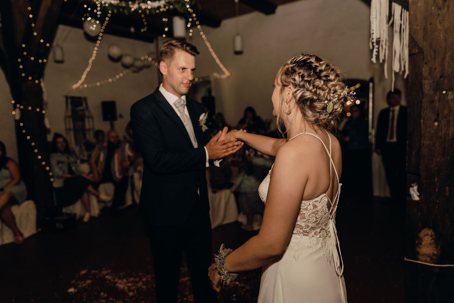 Wedding celebration dance floor scene with soft lighting and festive atmosphere.