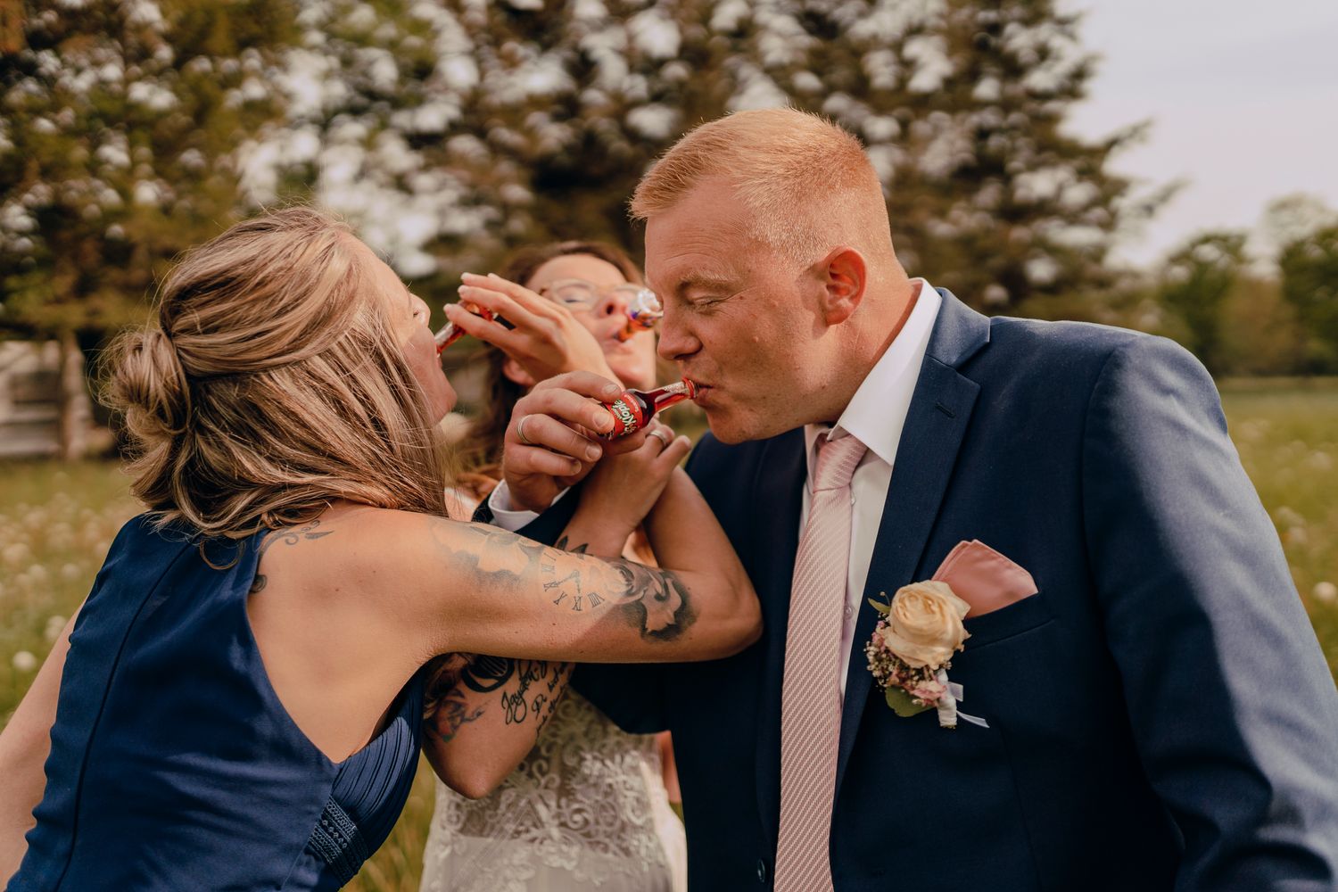Wedding couple sharing intimate romantic moments in an outdoor natural setting against evergreen trees.