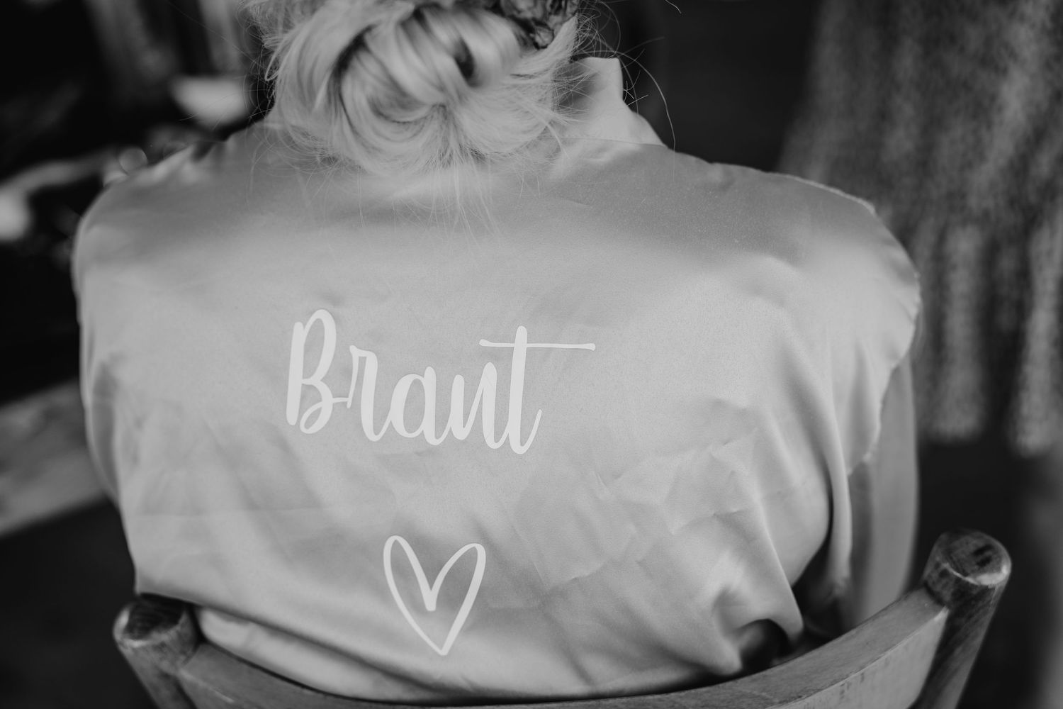 Wedding robes and hangers displayed with white customized text and decorative elements.