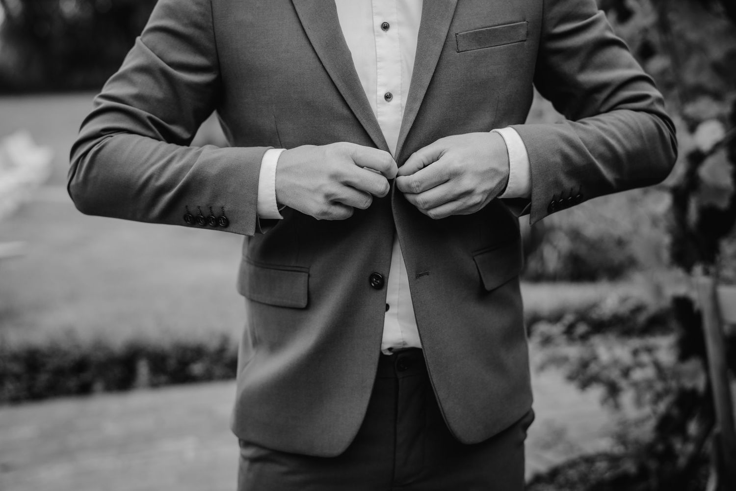 Classic grey suit with white dress shirt detail captured in black and white.
