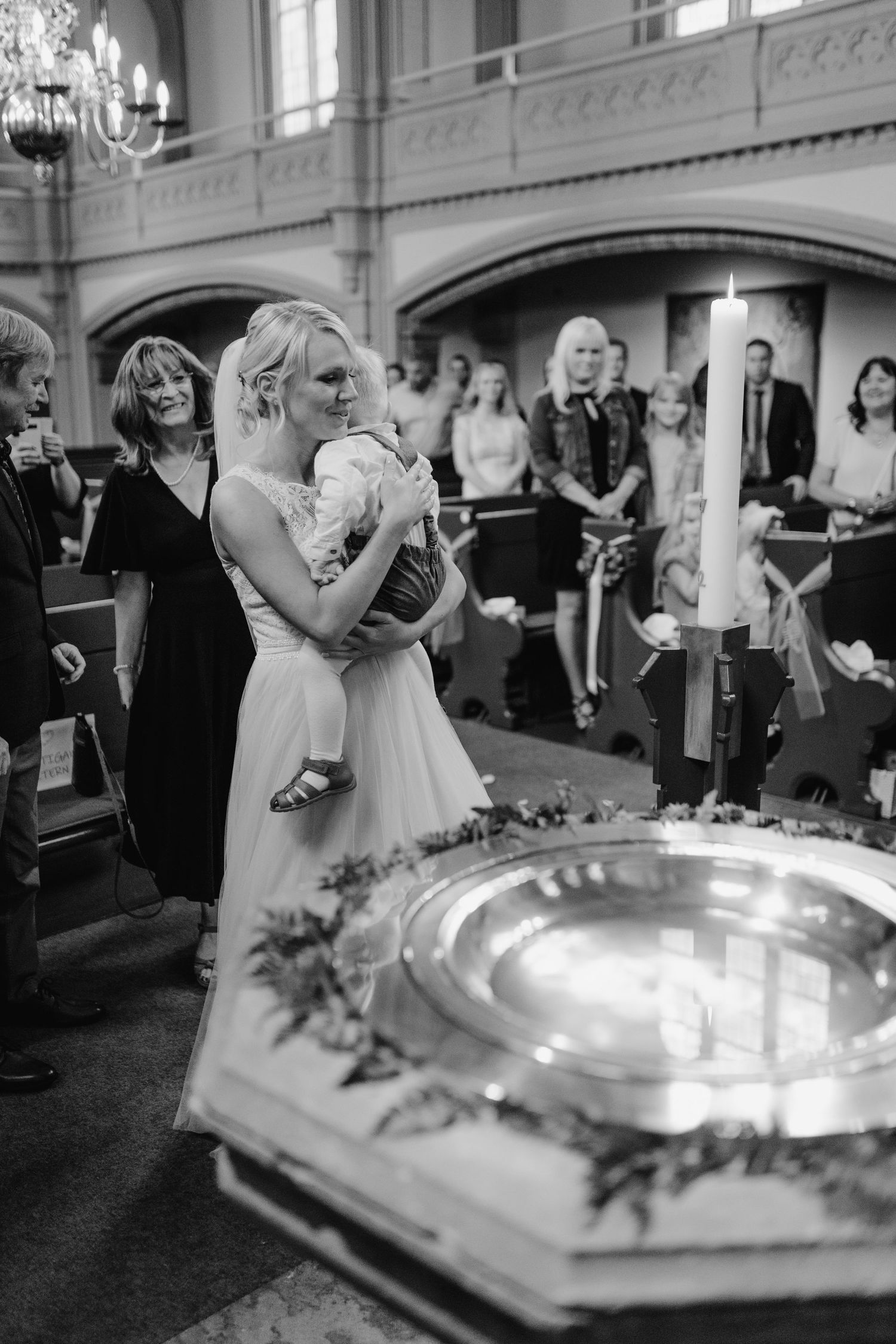 A sequence of black and white photos showing a couple's first dance at a wedding reception with elegant decor.