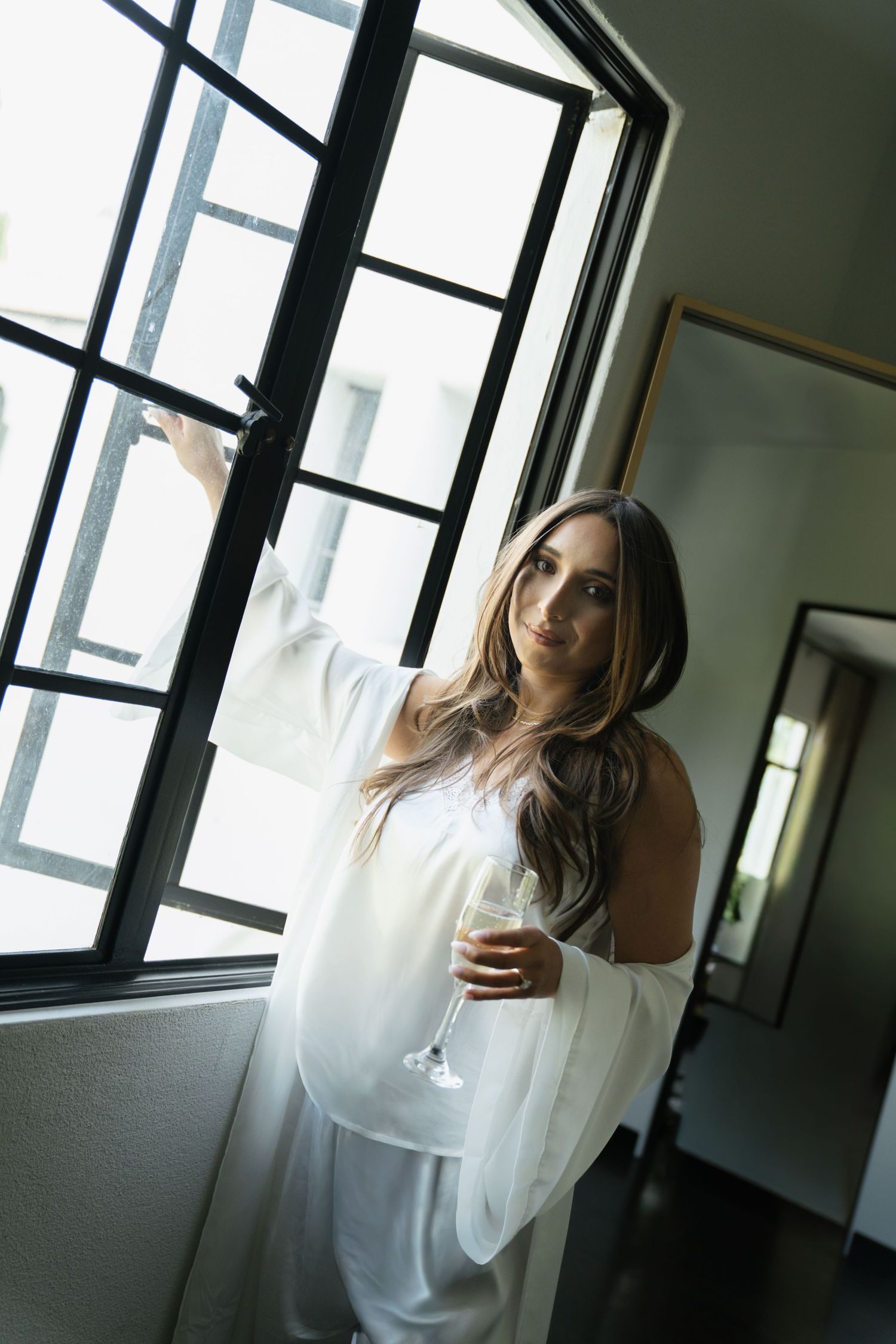 bride in pjs opening window