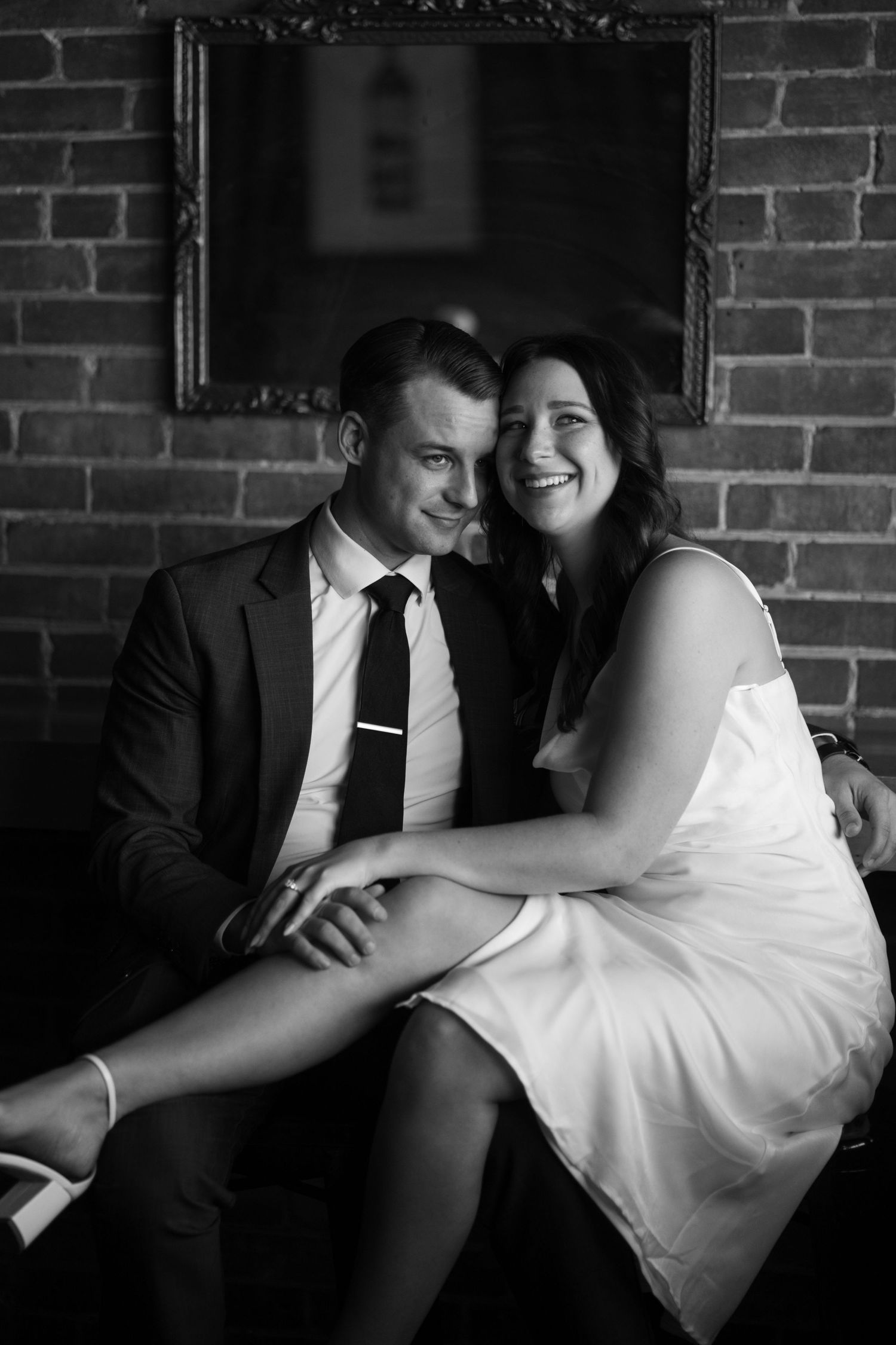 black and white photo of couple laughing in a bar