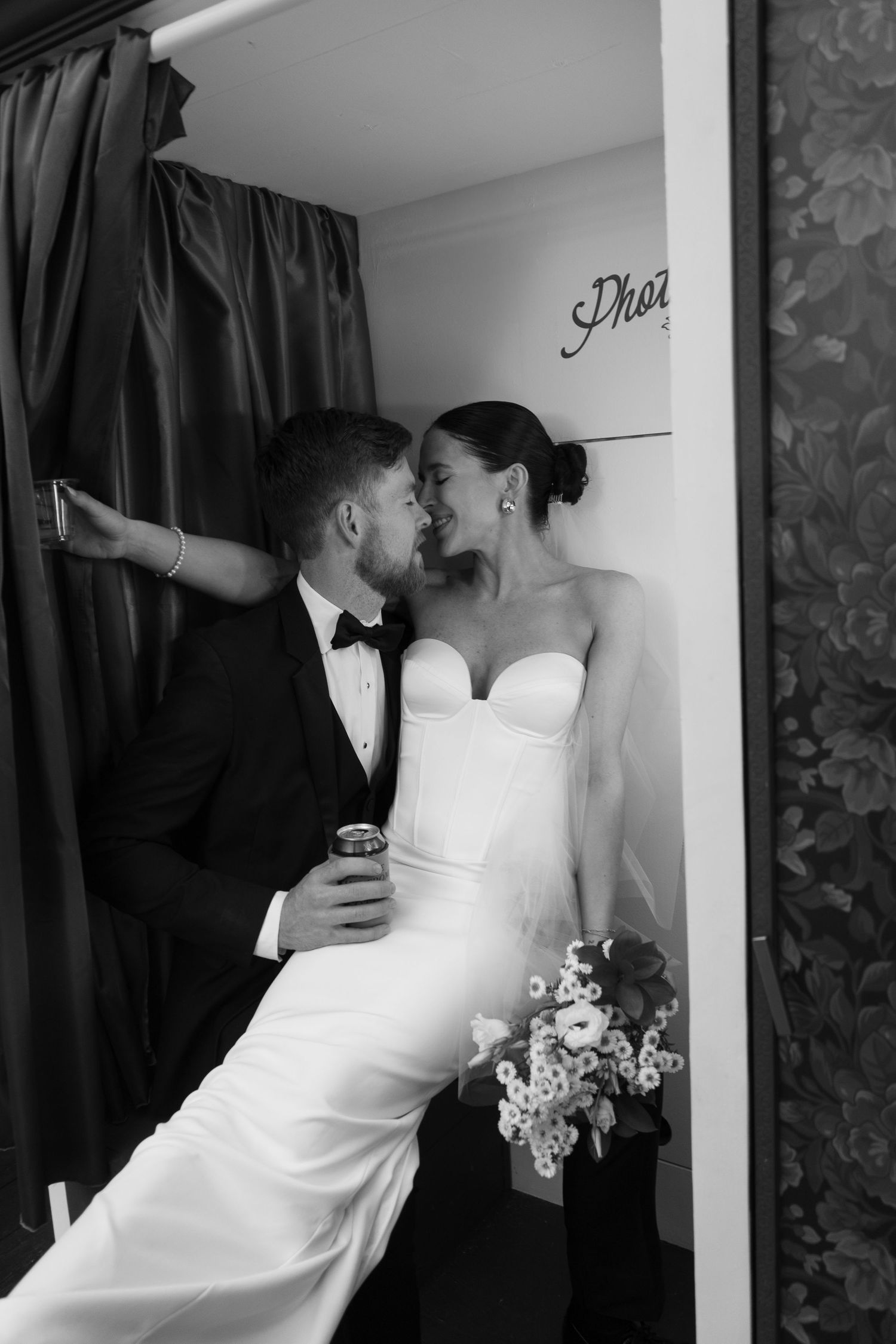 bride and groom kissing in Photo Booth
