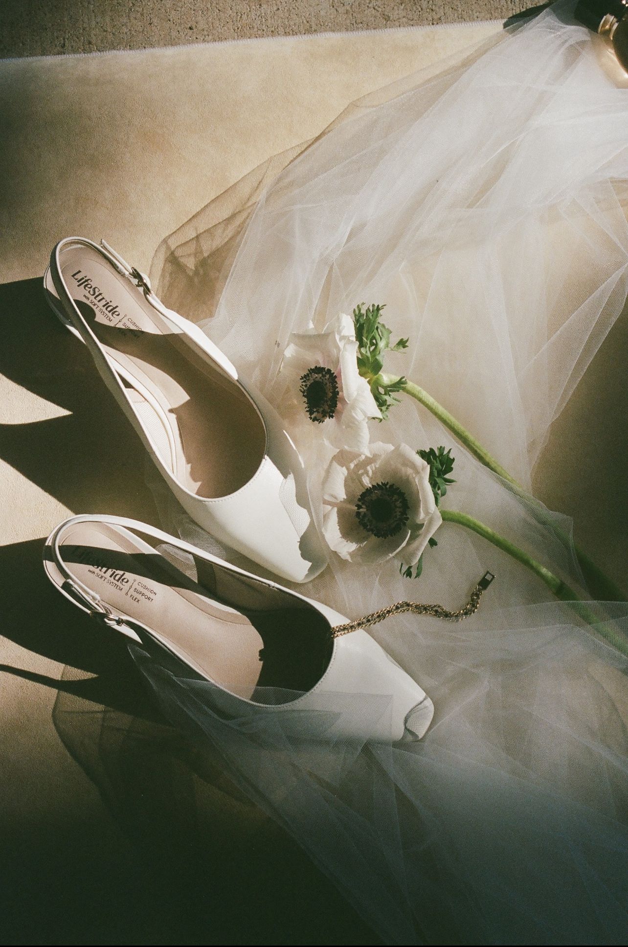 artful flat lay of bride's shoes