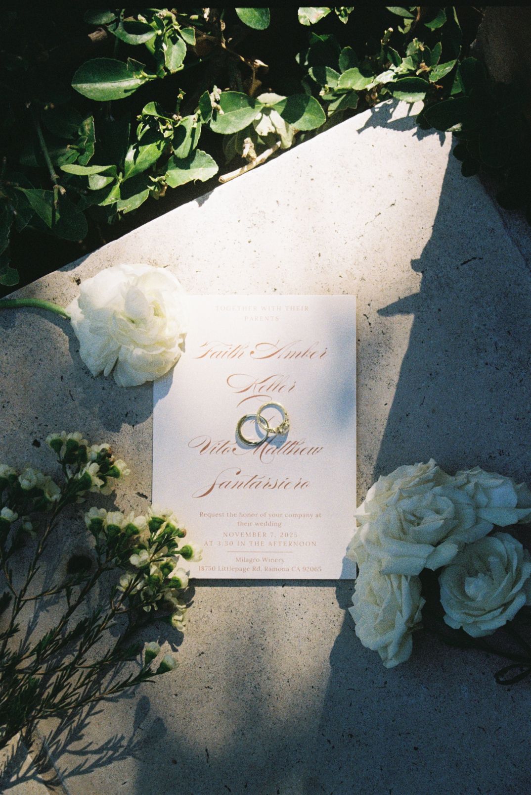 film flat lay of wedding invite and rings
