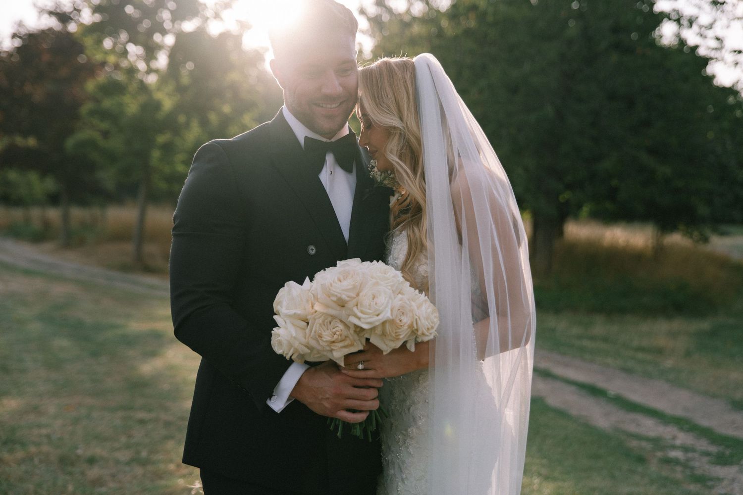 A romantic wedding sequence featuring tender moments between a couple under natural lighting in an outdoor setting.