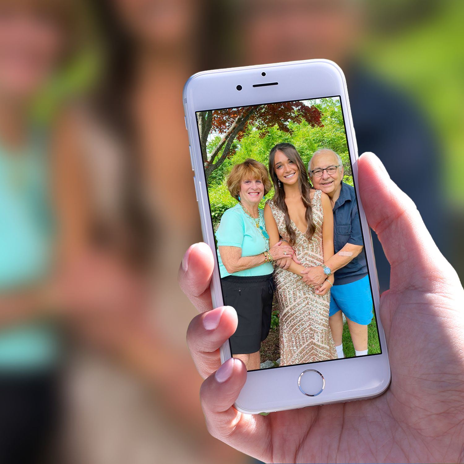 iPhone camera photo of a couple hugging their granddaughter.